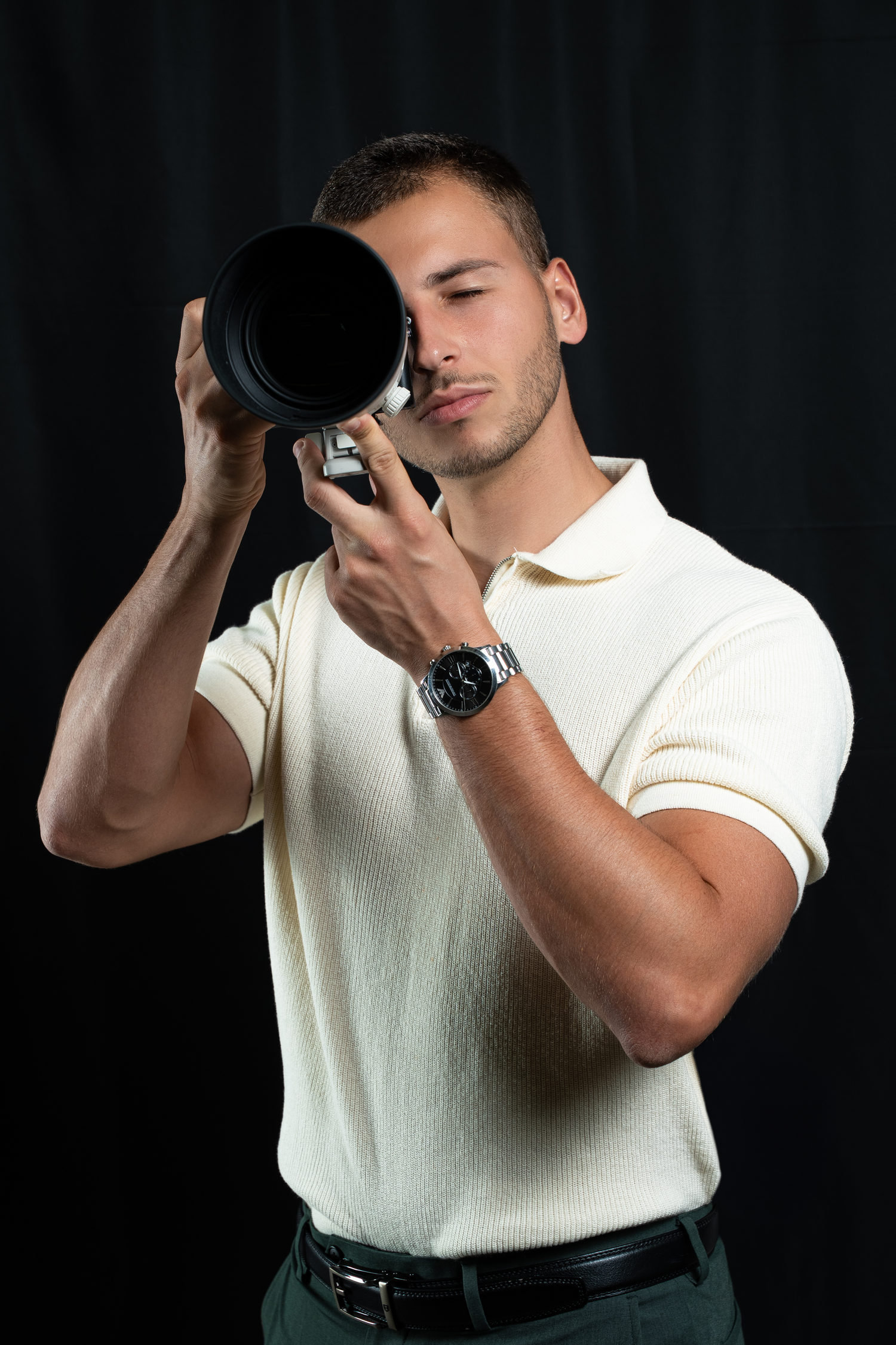 Person in white shirt demonstrating different camera angles against black background.