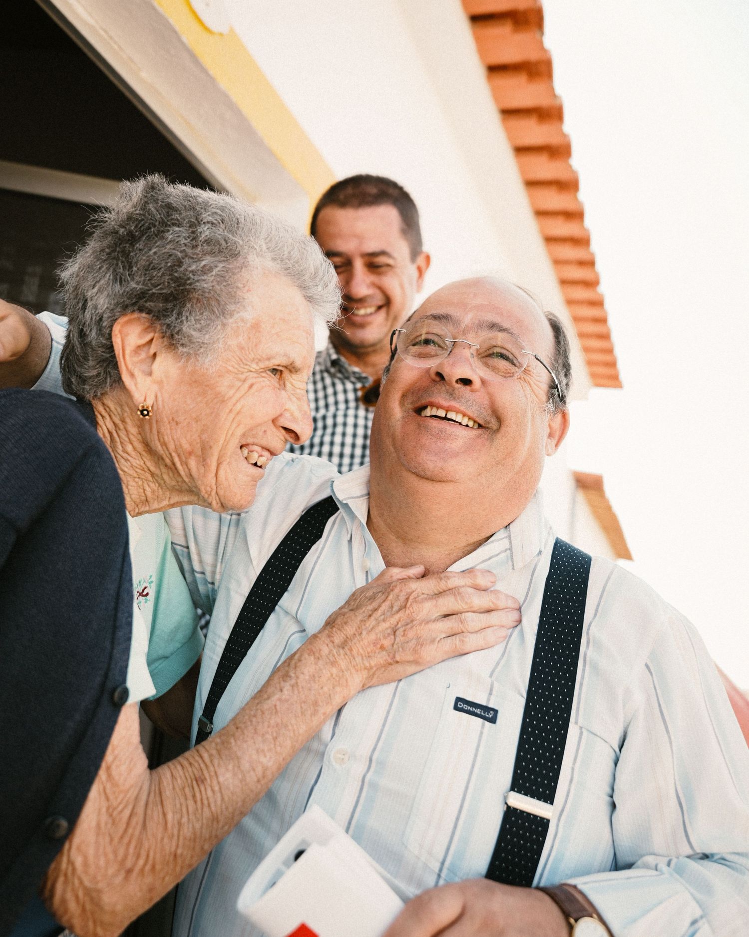 Candid moments of laughter and joy shared between two people during a heartwarming interaction.