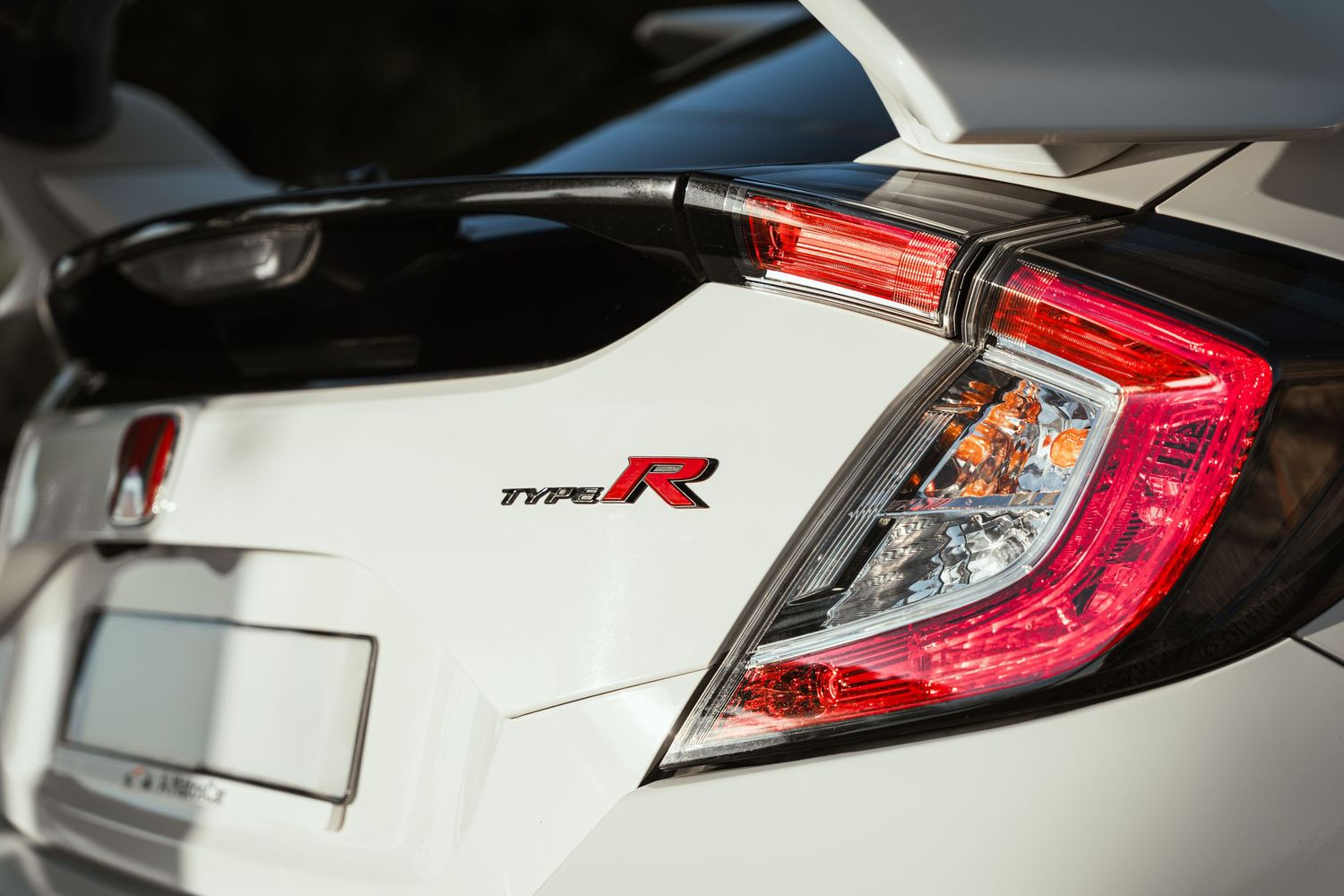Close-up details of white car taillights showing modern LED design elements.