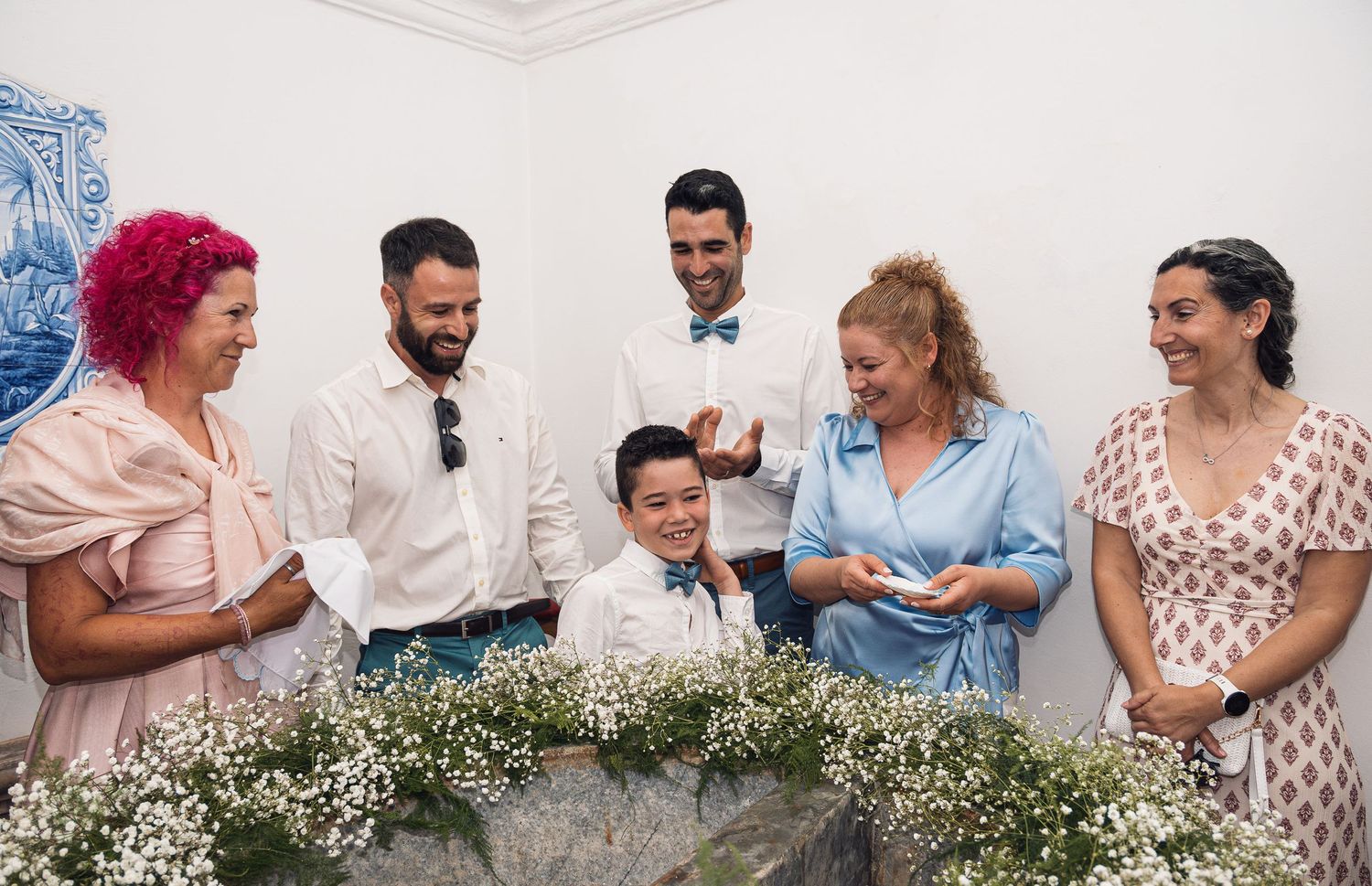 Panoramic family photo with baby's breath flowers and coordinated outfits.