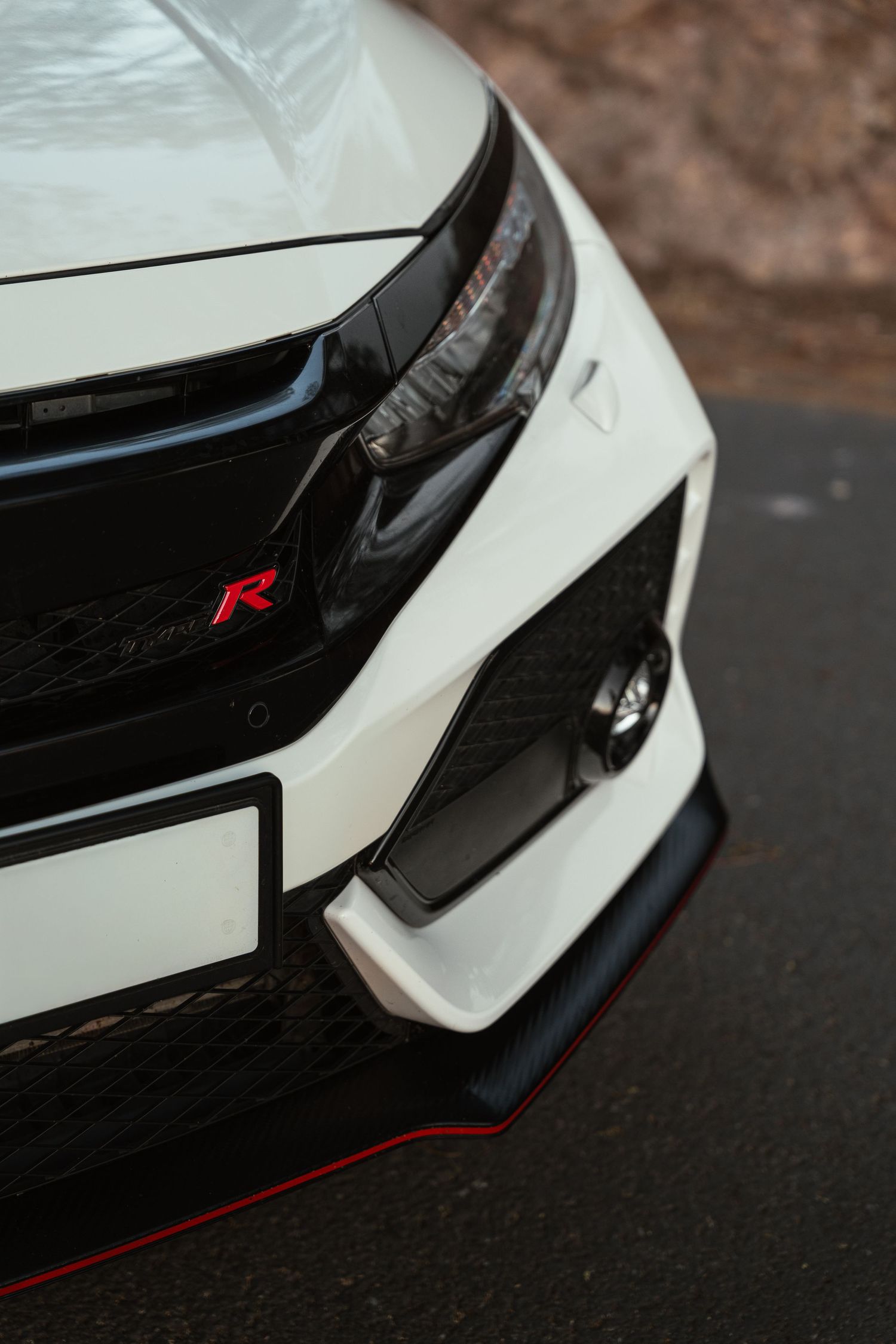 Detailed close-up shots of white Honda Civic Type R front grille and red accents.