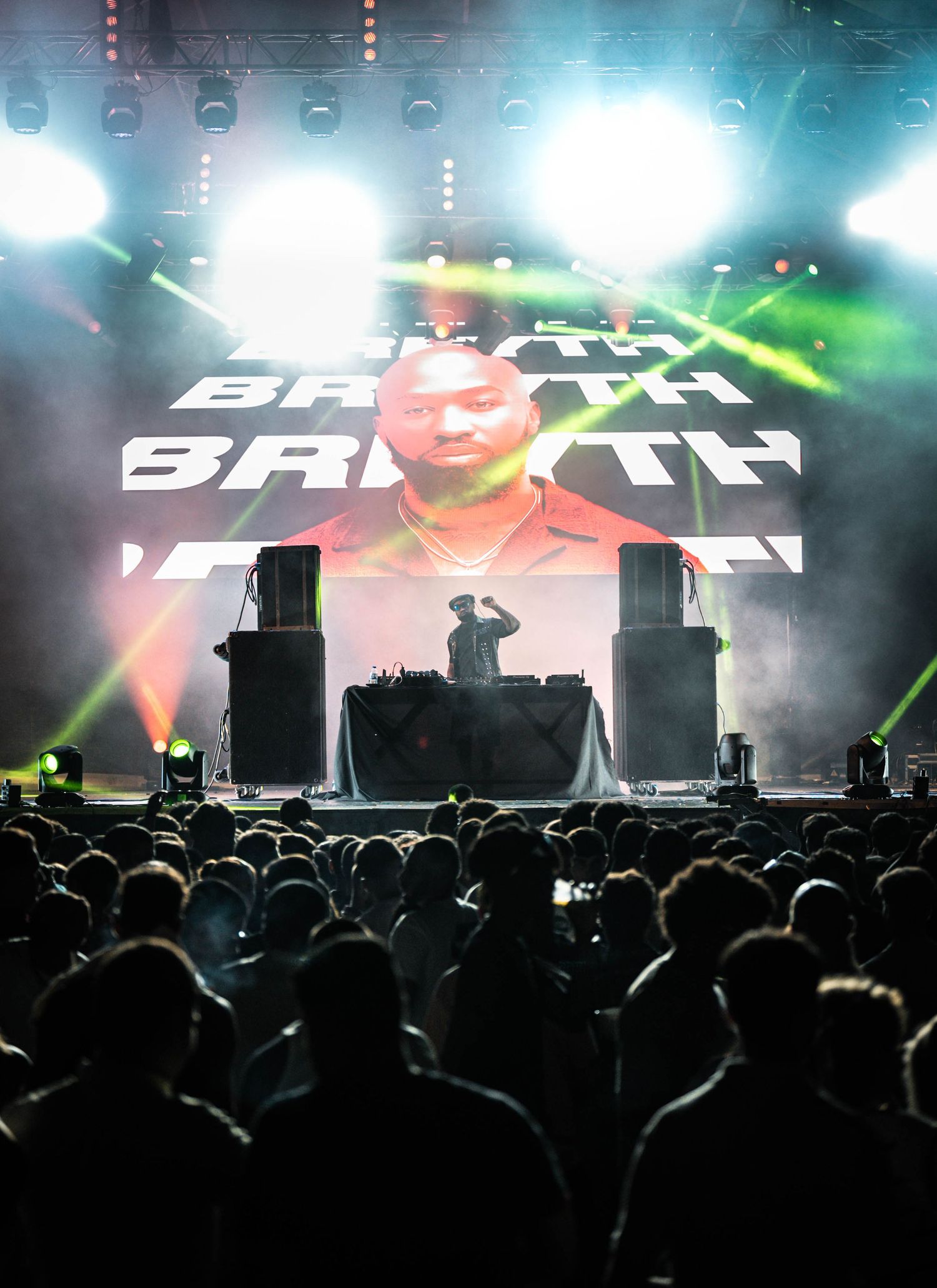 Electronic music stage setup with Breyth logo display and dramatic lighting effects.