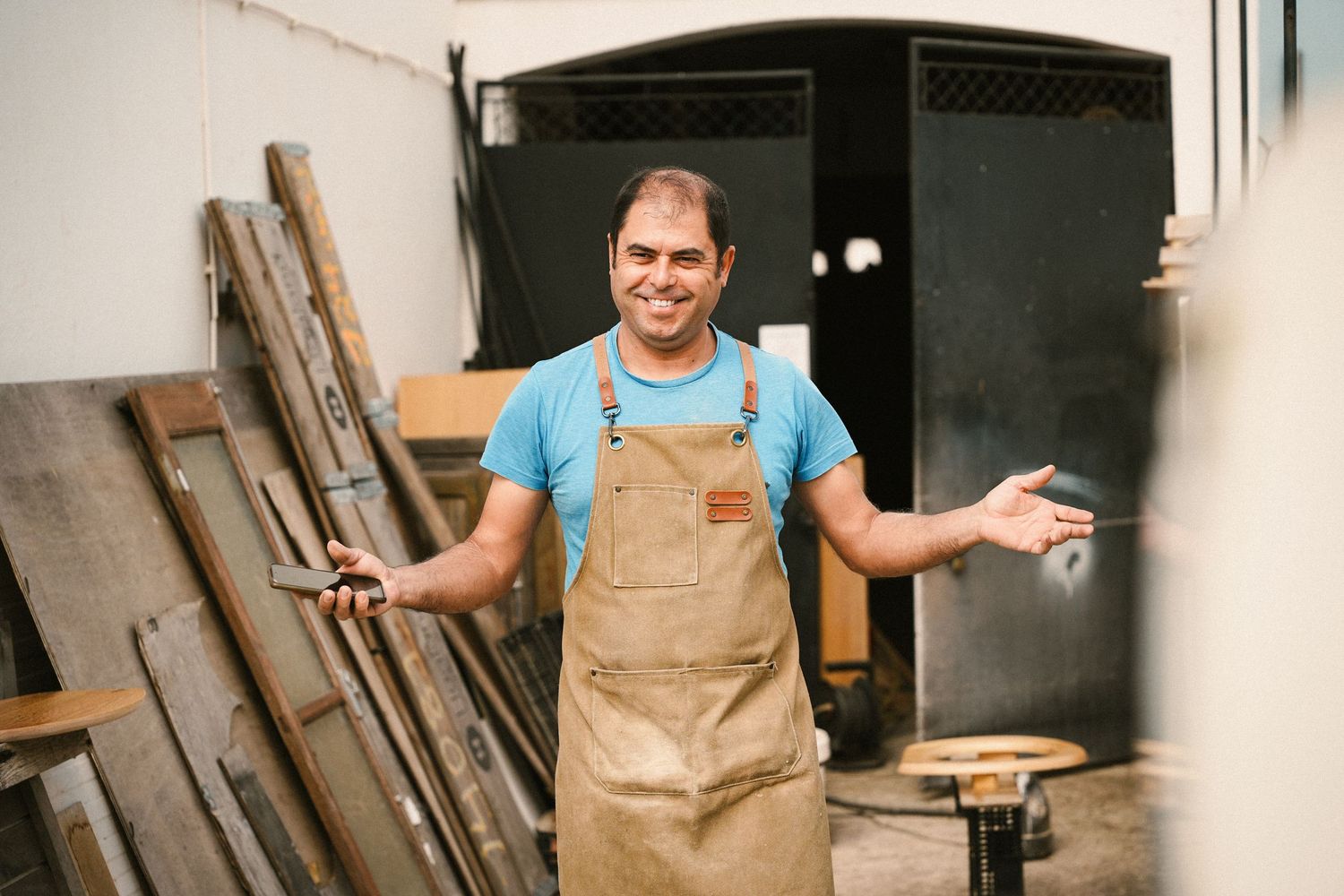 People in casual attire having fun and socializing in a workshop or studio space.