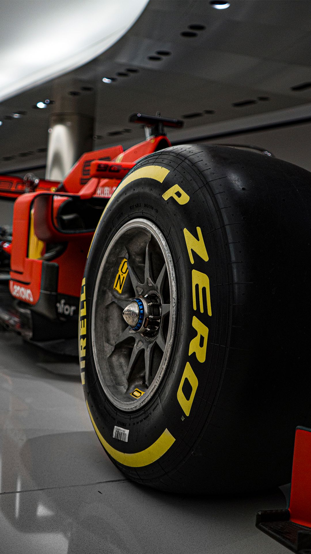 Close-up of Pirelli P Zero Formula 1 racing tires on Ferrari race car.