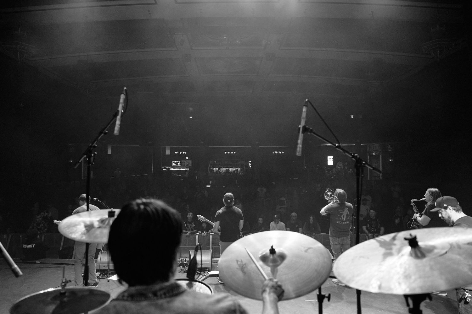 Black and white view from the drum kit on stage during a live performance