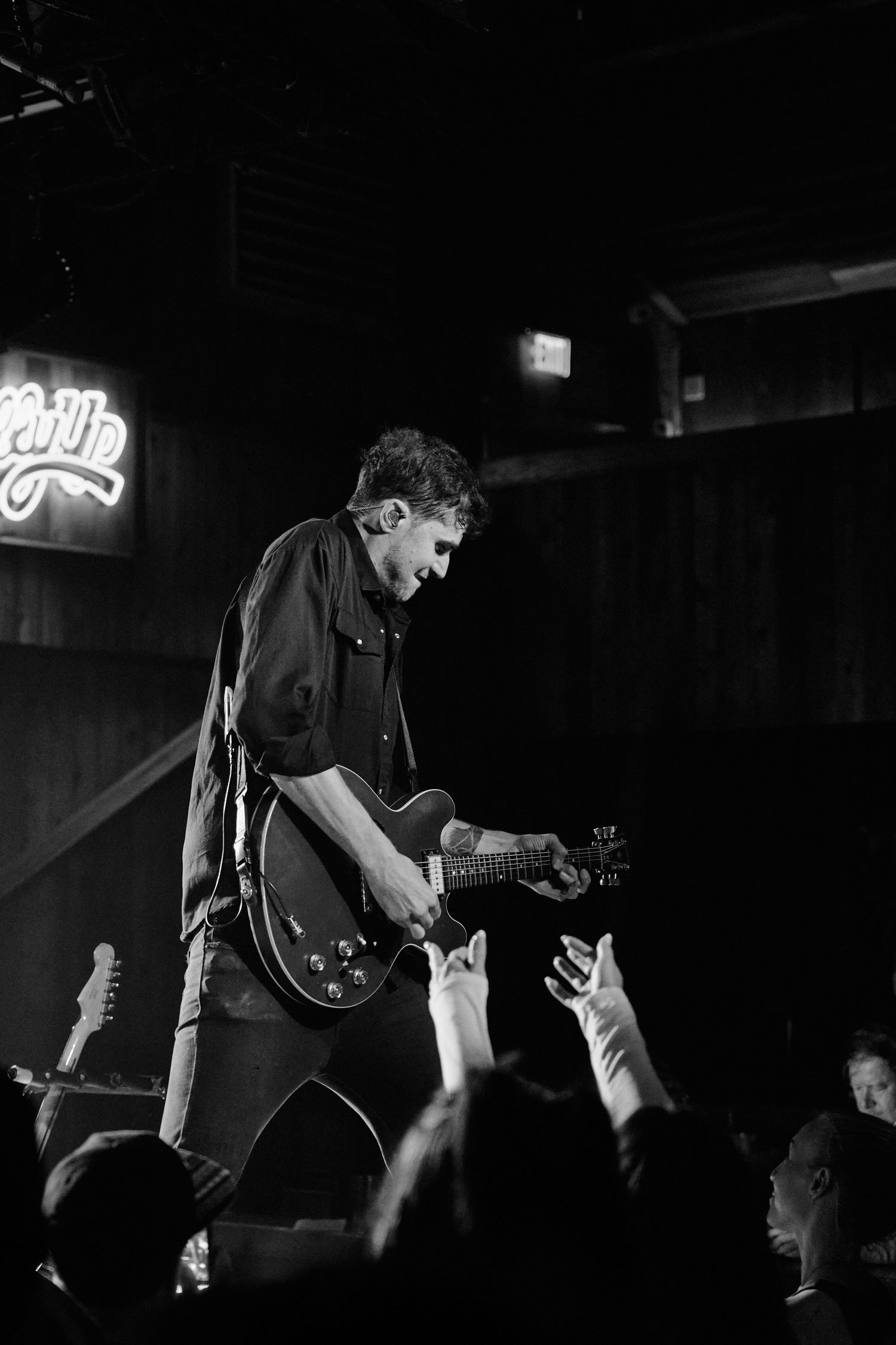 Black and white photo of guitarist performing to a crowd