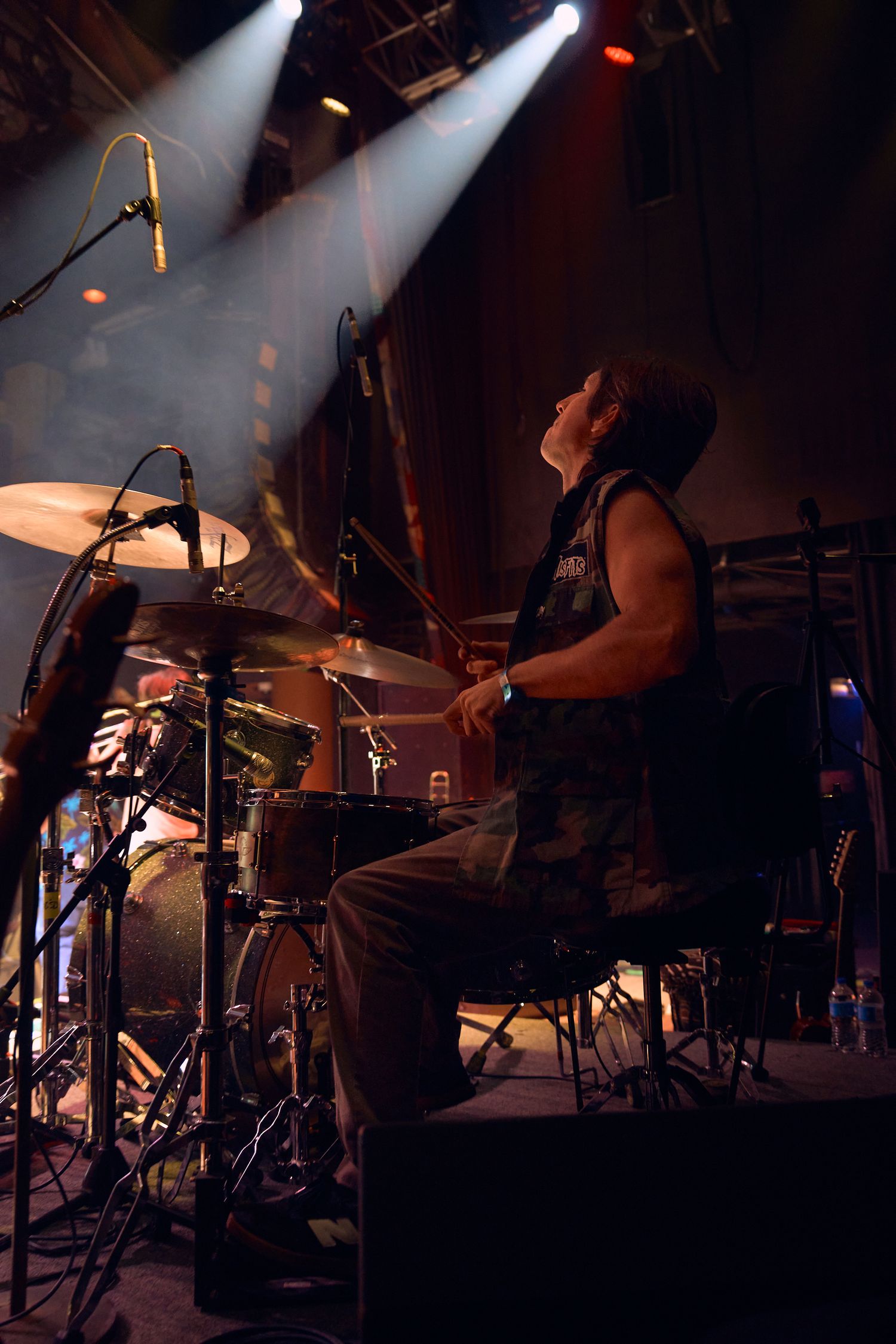 Drummer performing on stage during a live concert