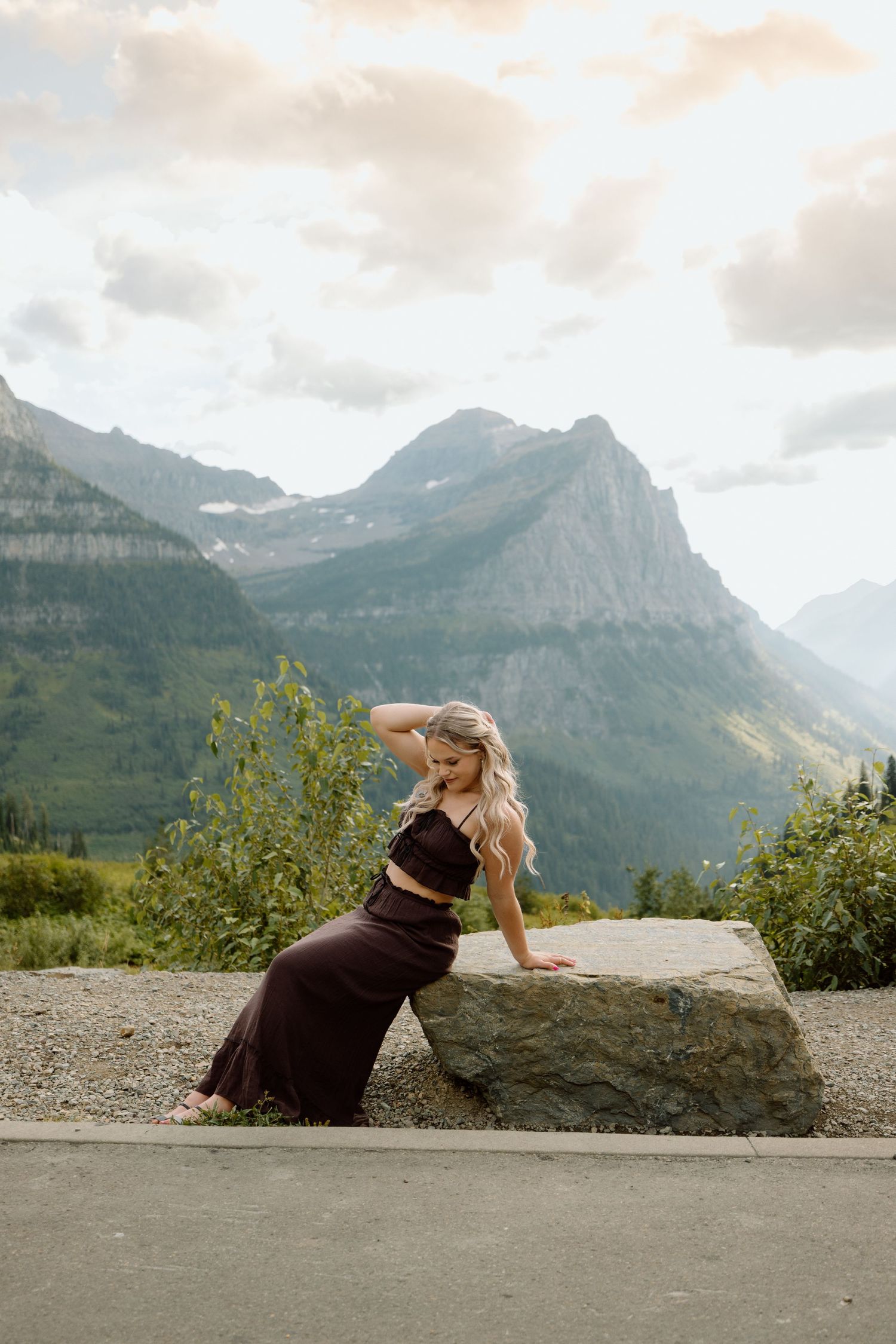 A scenic mountain landscape with dramatic peaks and clouds in Glacier National Park.