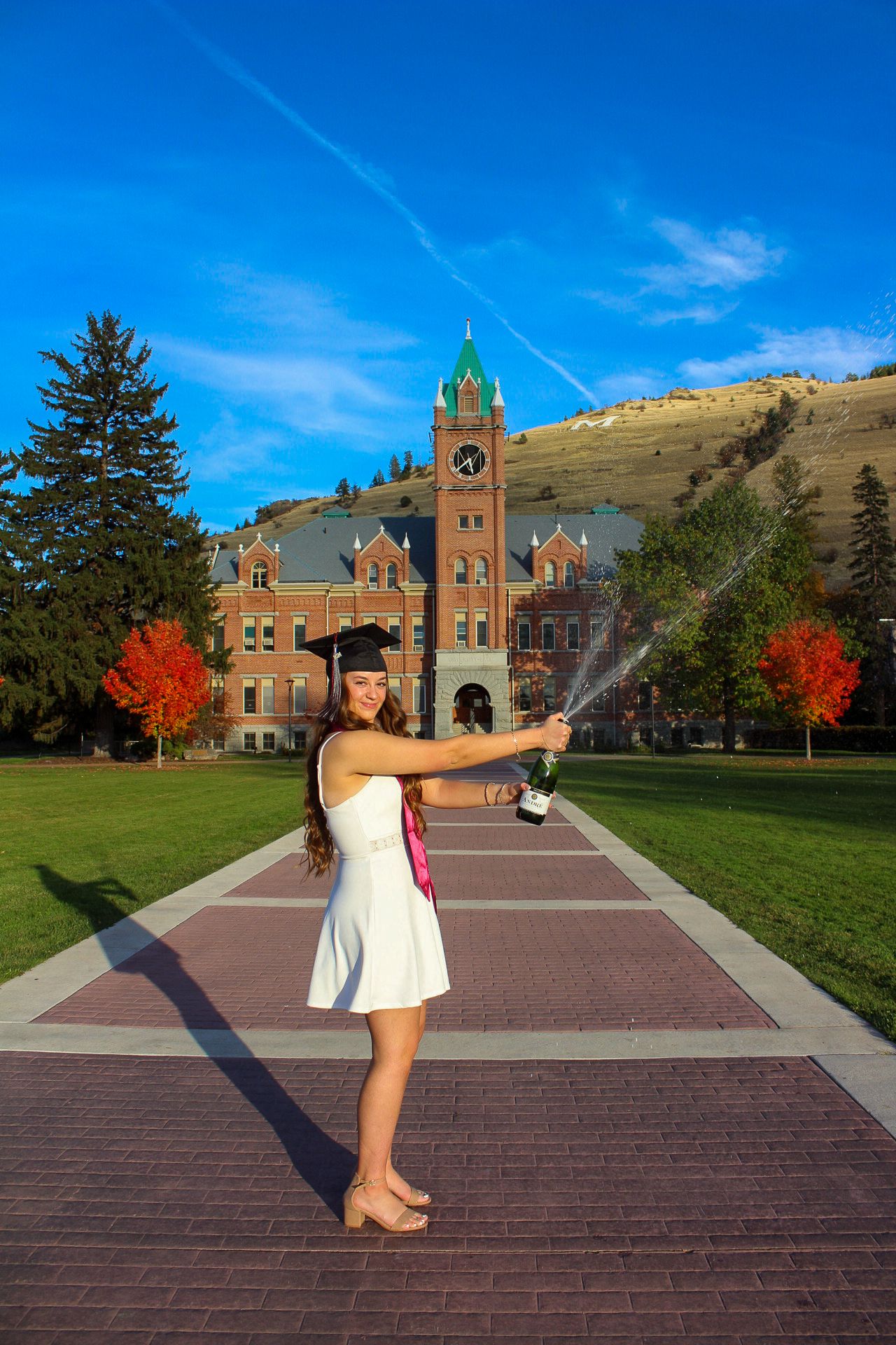 A series of photos show acrobatic poses in front of a historic brick university building on a sunny autumn day.