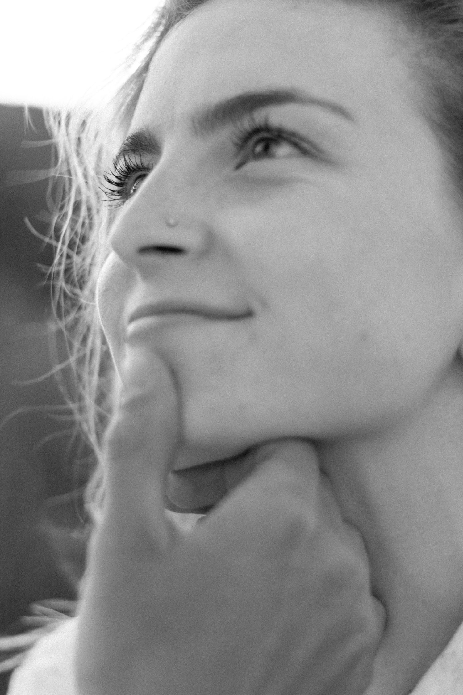 Black and white close-up profile shots showing joyful laughter and emotional expressions.