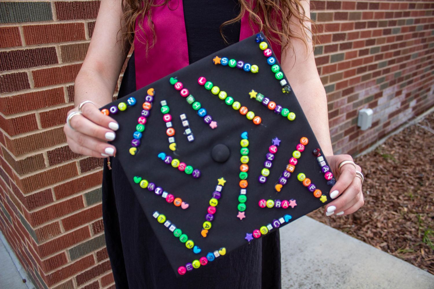 A sequined dress detail shows colorful dots arranged in geometric patterns against a black background.