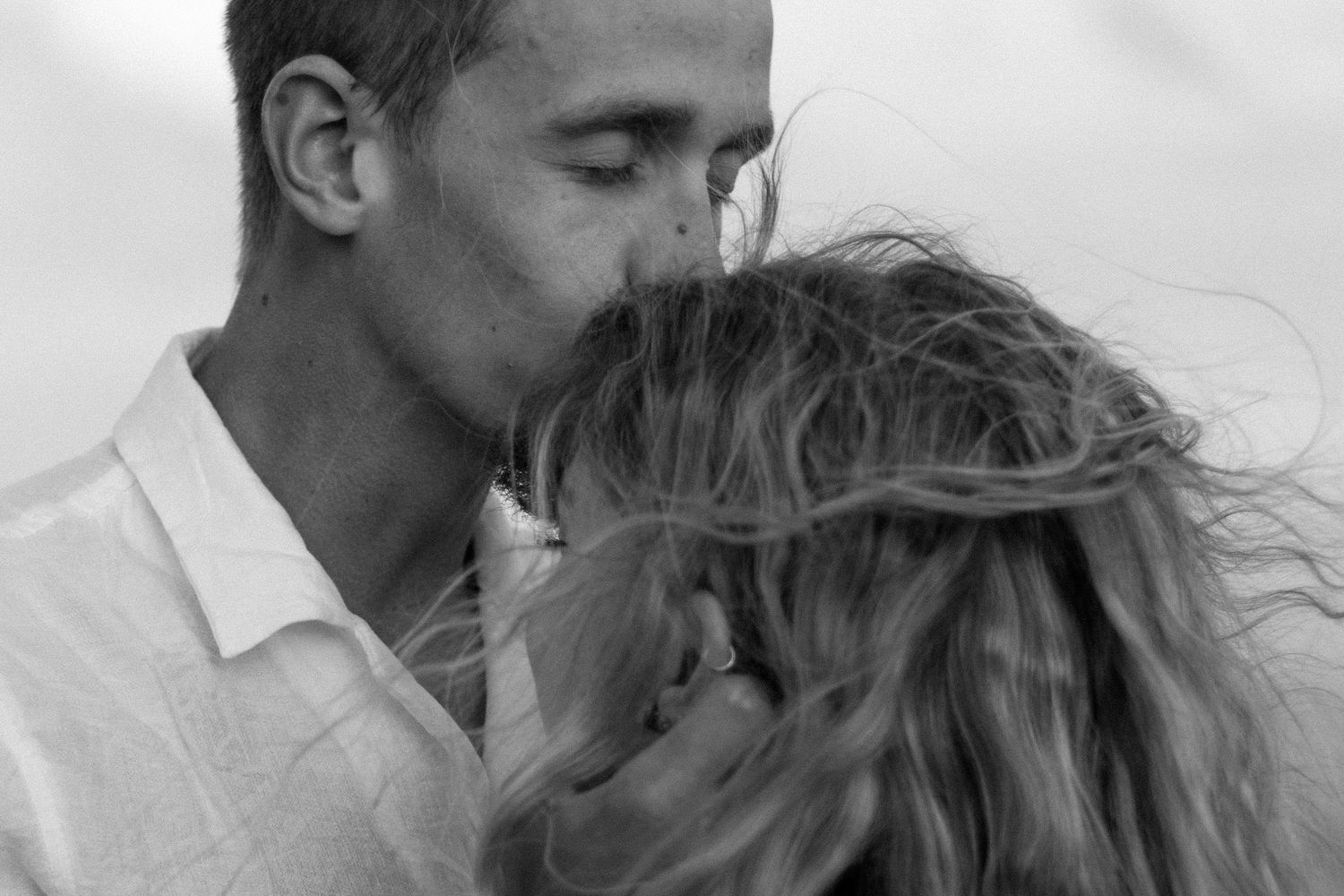 Close-up black and white photo series capturing intimate romantic moments between a couple.