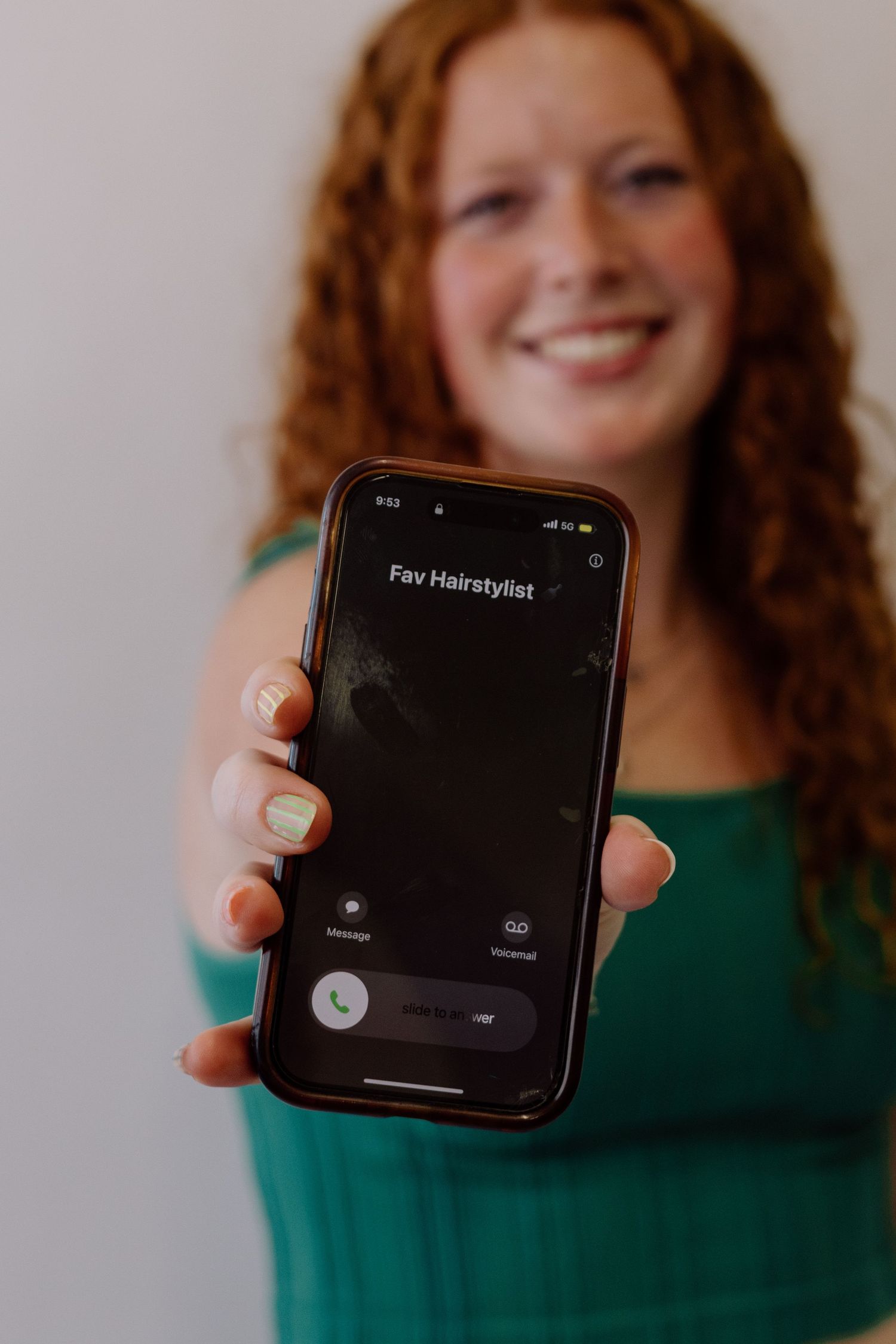 Person showing dark phone screen against white background.