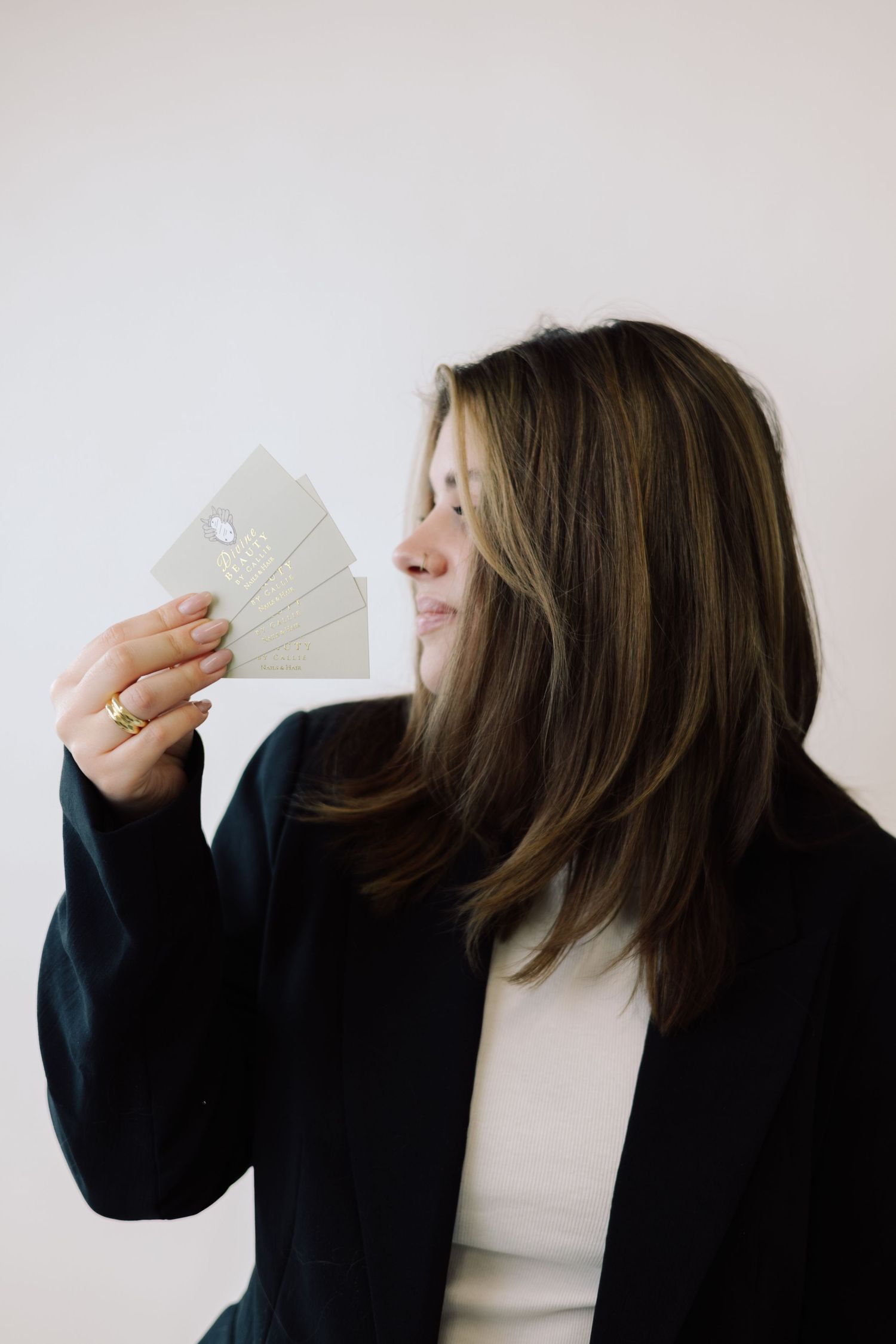 A sequence of artistic self-portraits showing someone holding cash against a white background.