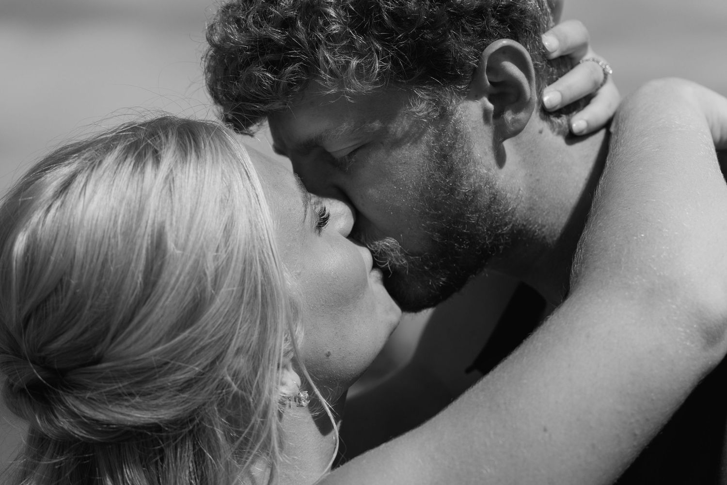 A series of romantic black and white photographs showing intimate moments between couples embracing and kissing.