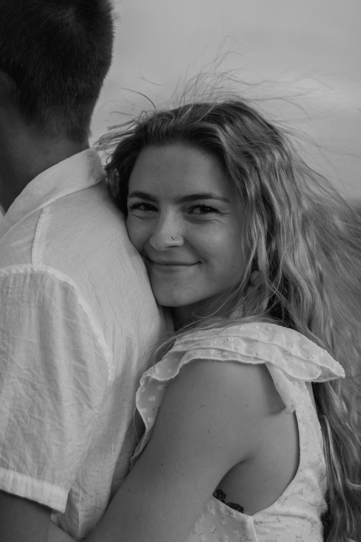 Black and white portrait series showing a woman with blonde hair against a light background in different poses.