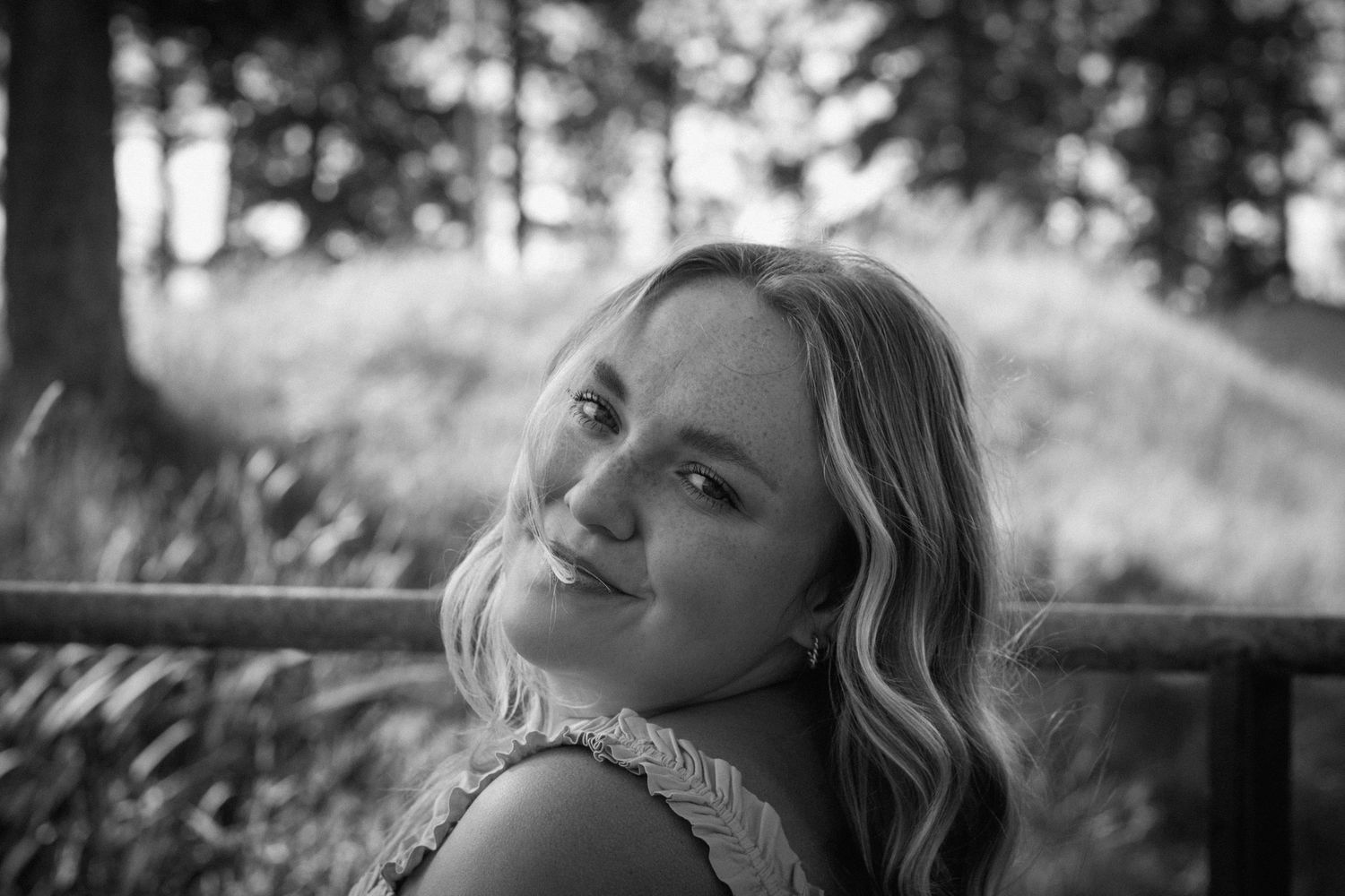 Black and white photo of someone gazing upward with dramatic lighting and shadows in a dreamlike scene.