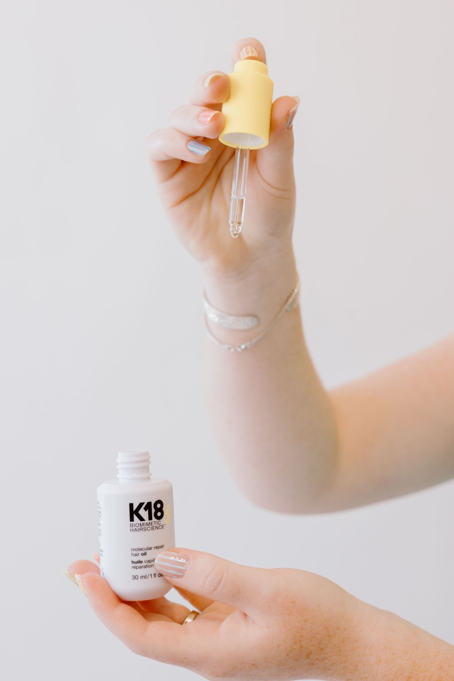 Multiple skincare product bottles and containers being displayed on a white surface.
