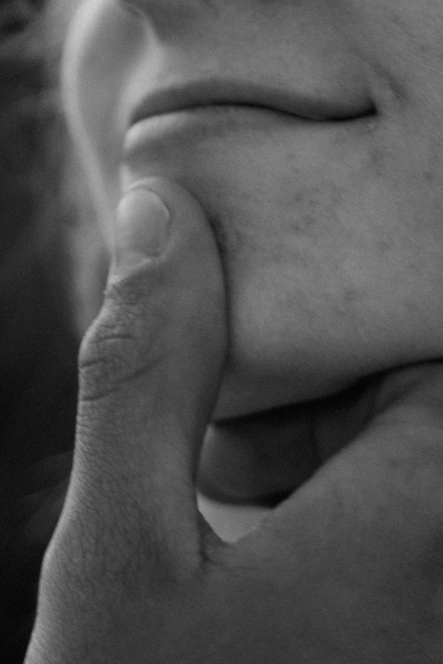 Extreme close-up black and white detail of lips and skin texture.