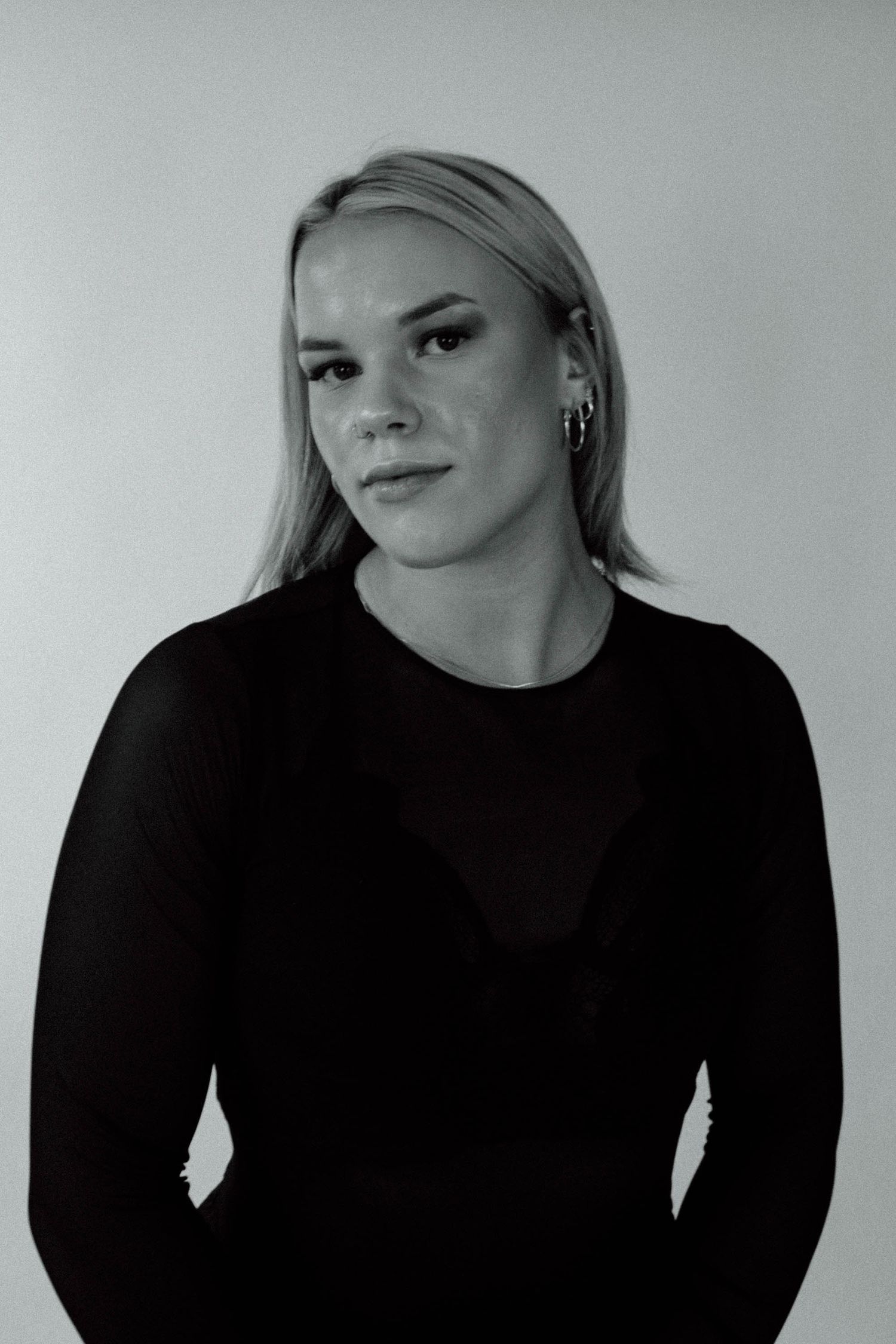 A series of black and white portrait shots showing different angles and expressions in a minimalist style.