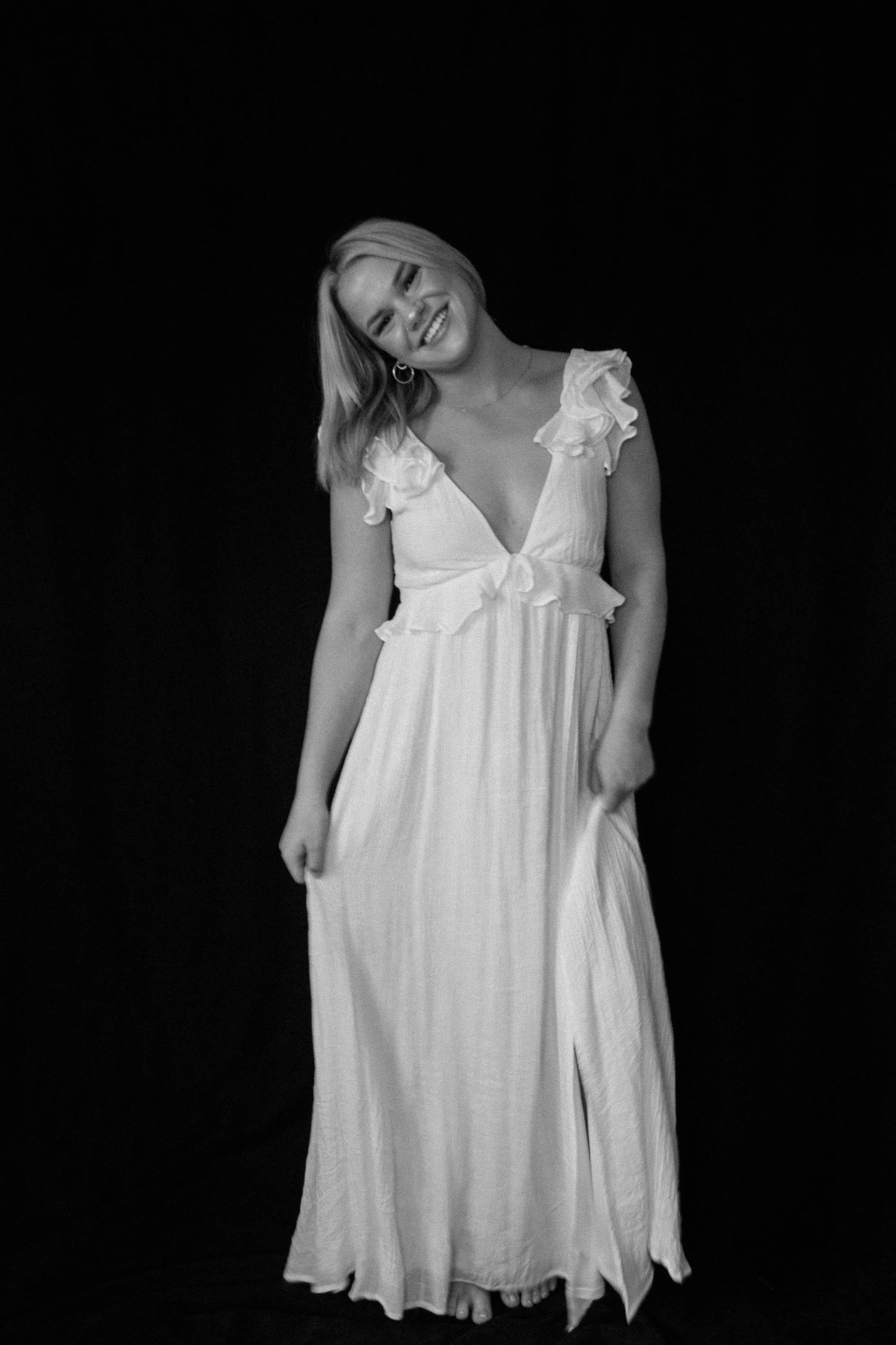 Black and white photos of a flowing white nightgown dress displayed in different angles against dark background.
