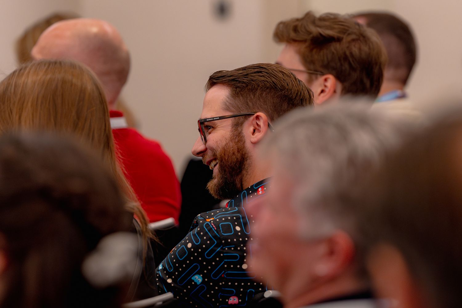 Ein lachender Teilnehmer, der sich Keynote der ColorCloud Konferenz anhört