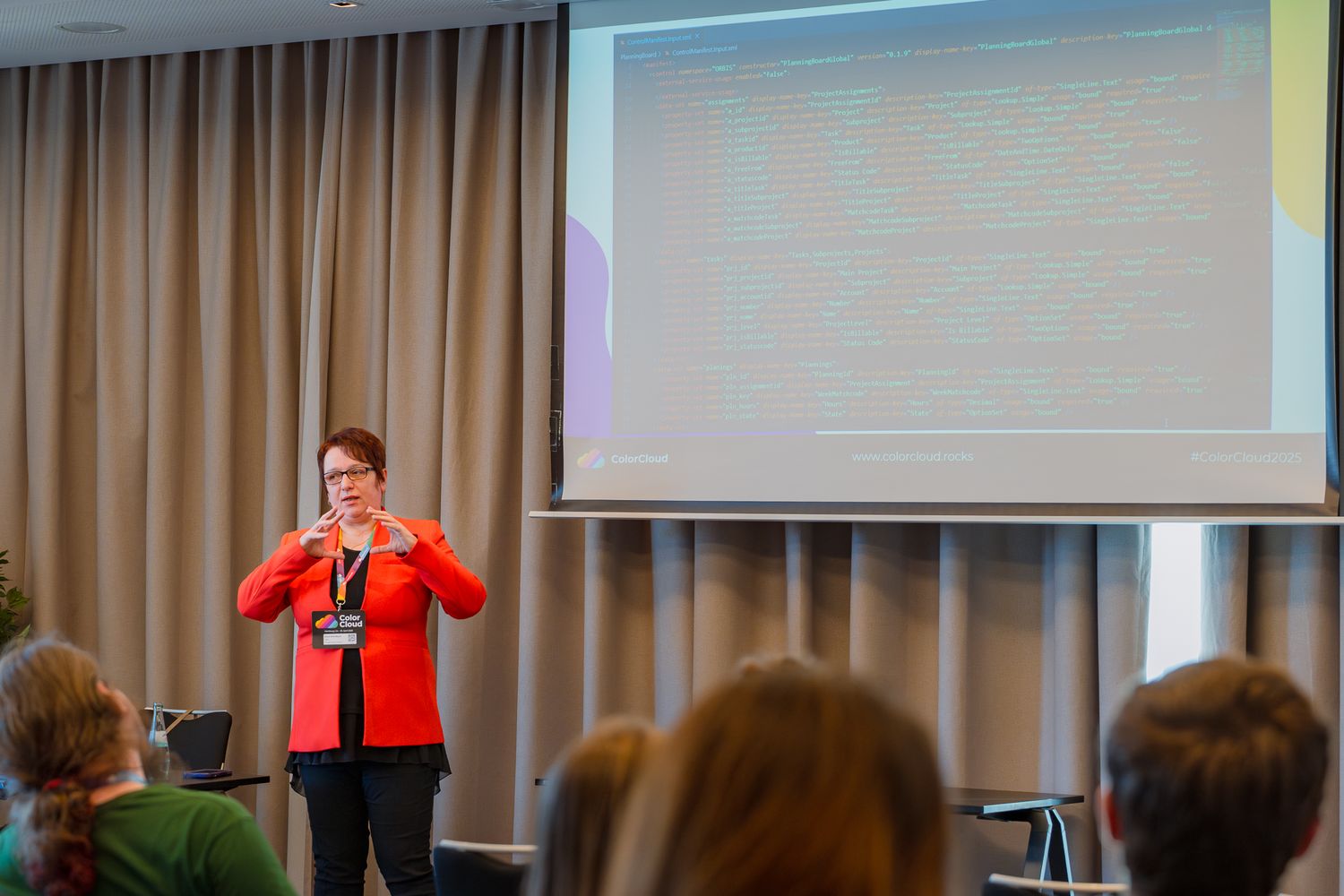Diana Birkelbach hält neben einer Leinwand einen Vortrag auf der ColorCloud-Konferenz 2025