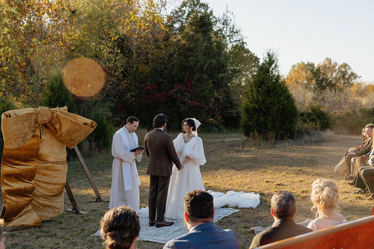 Ashley & Baron standing at the alter on their farmhouse property wedding in priceton kentucky