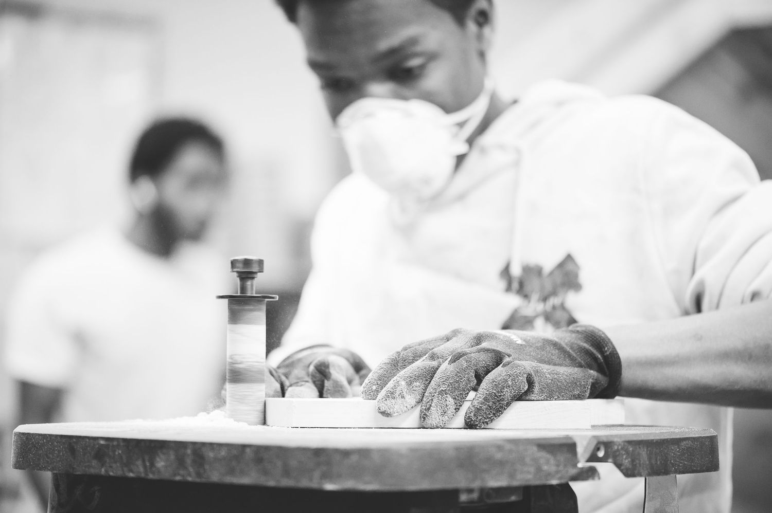 Close up of student on sanding machine