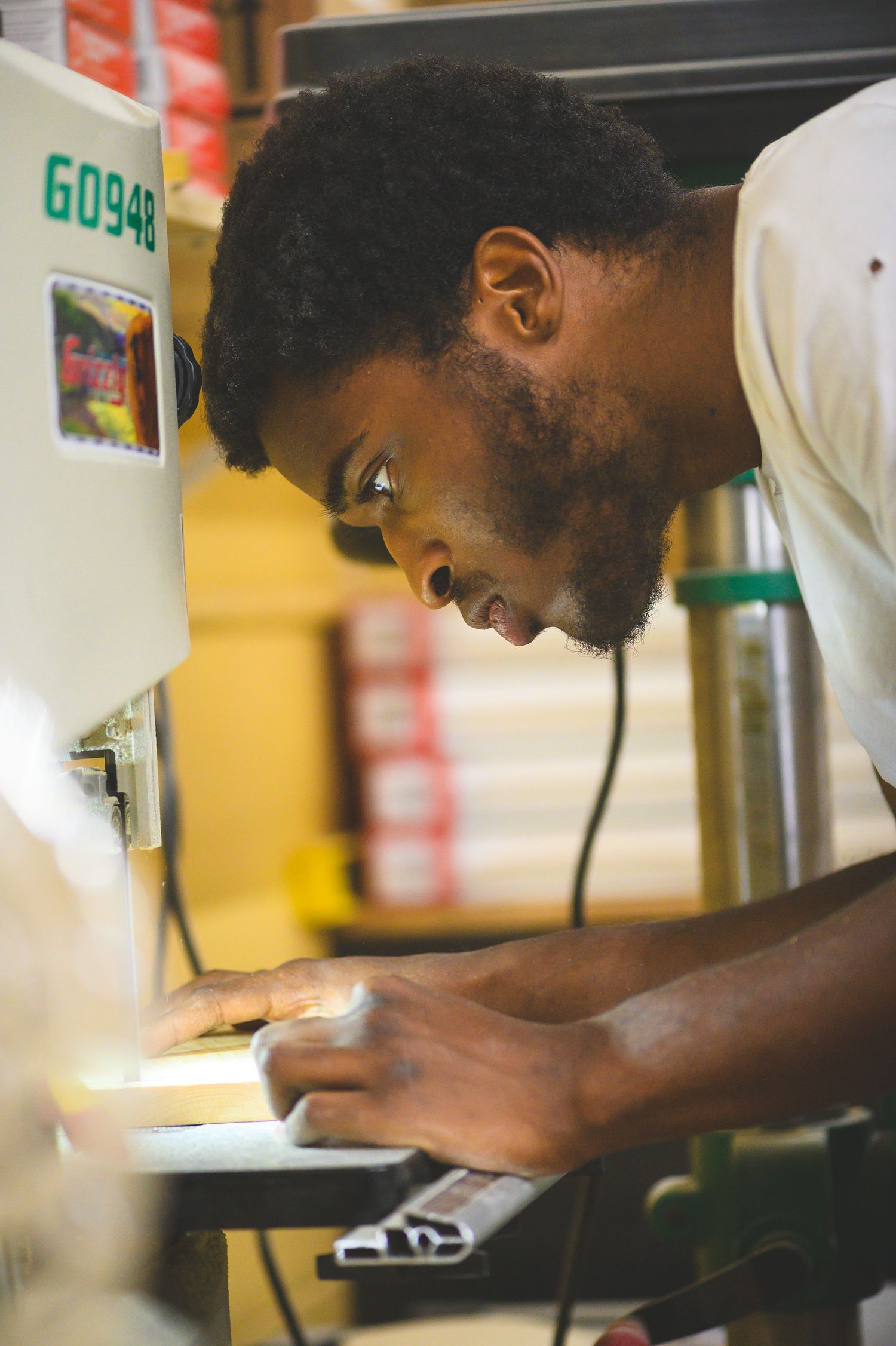 A close-up shot shows someone carefully preparing food in a commercial kitchen setting.
