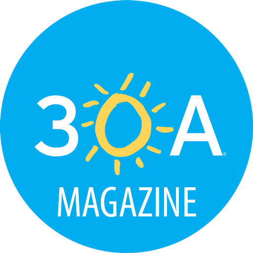 A circular blue logo for 30A Magazine featuring a stylized sun icon and white text.