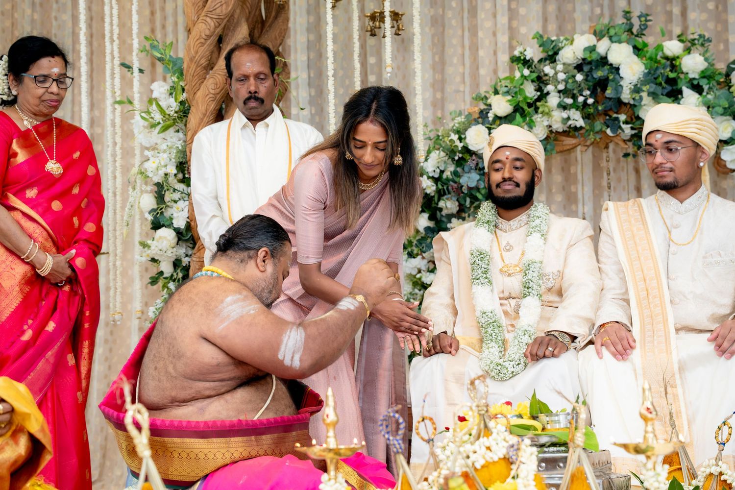 Hindu priest blesses the bride during a traditional South Indian wedding ceremony at the mandap.