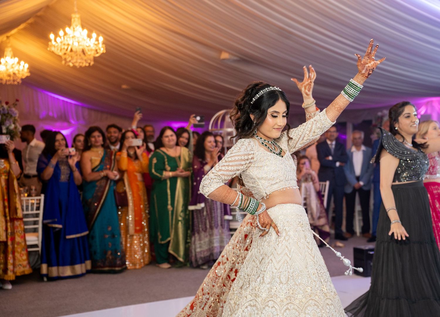 Bride in white lehenga performs a stunning Bollywood dance at her Indian wedding reception.