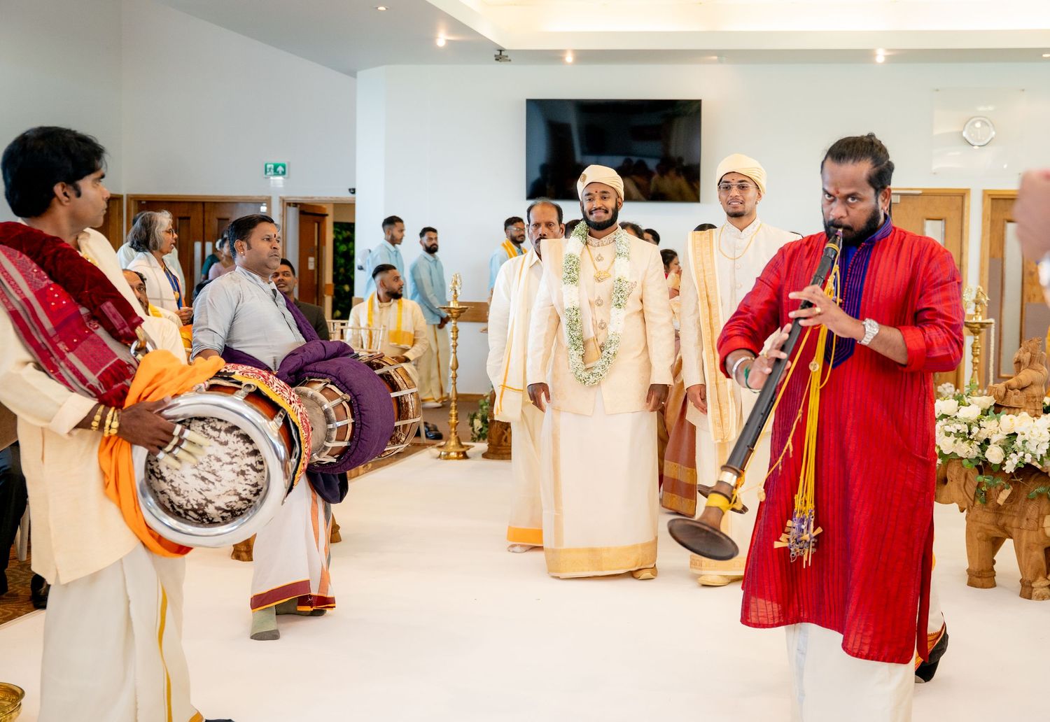 Traditional South Indian wedding musicians playing chenda drums and nadaswaram during a ceremony.