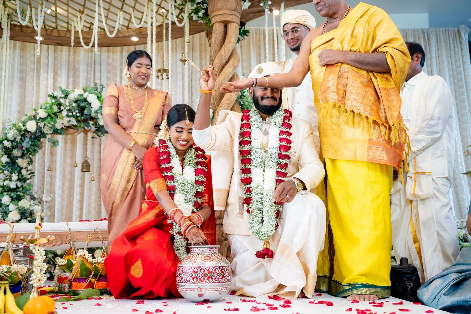 Priest blessing bride and groom during traditional South Indian Hindu wedding ceremony at mandap.