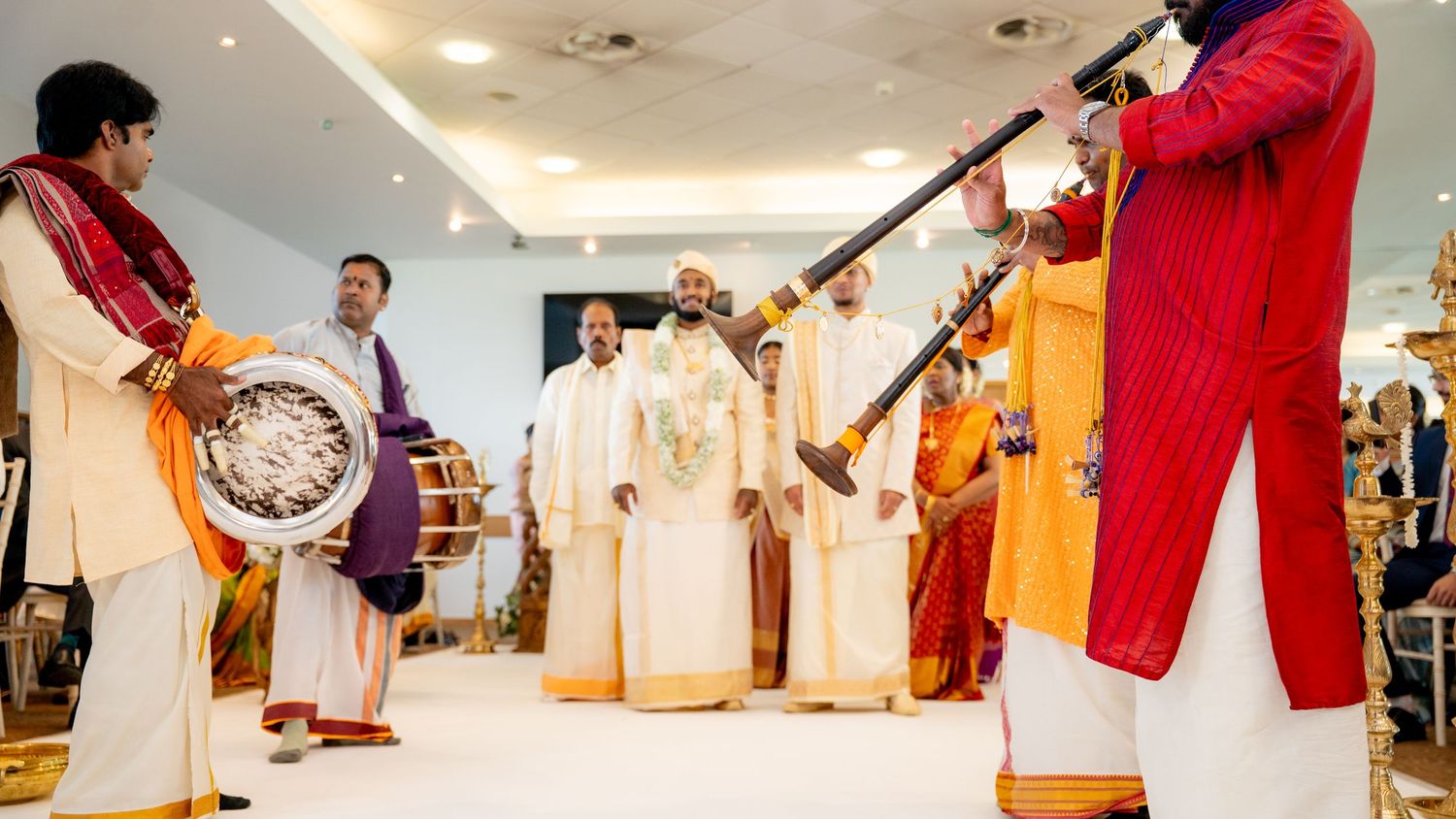 Traditional Kerala wedding musicians playing nadaswaram and chenda drums during a ceremony.