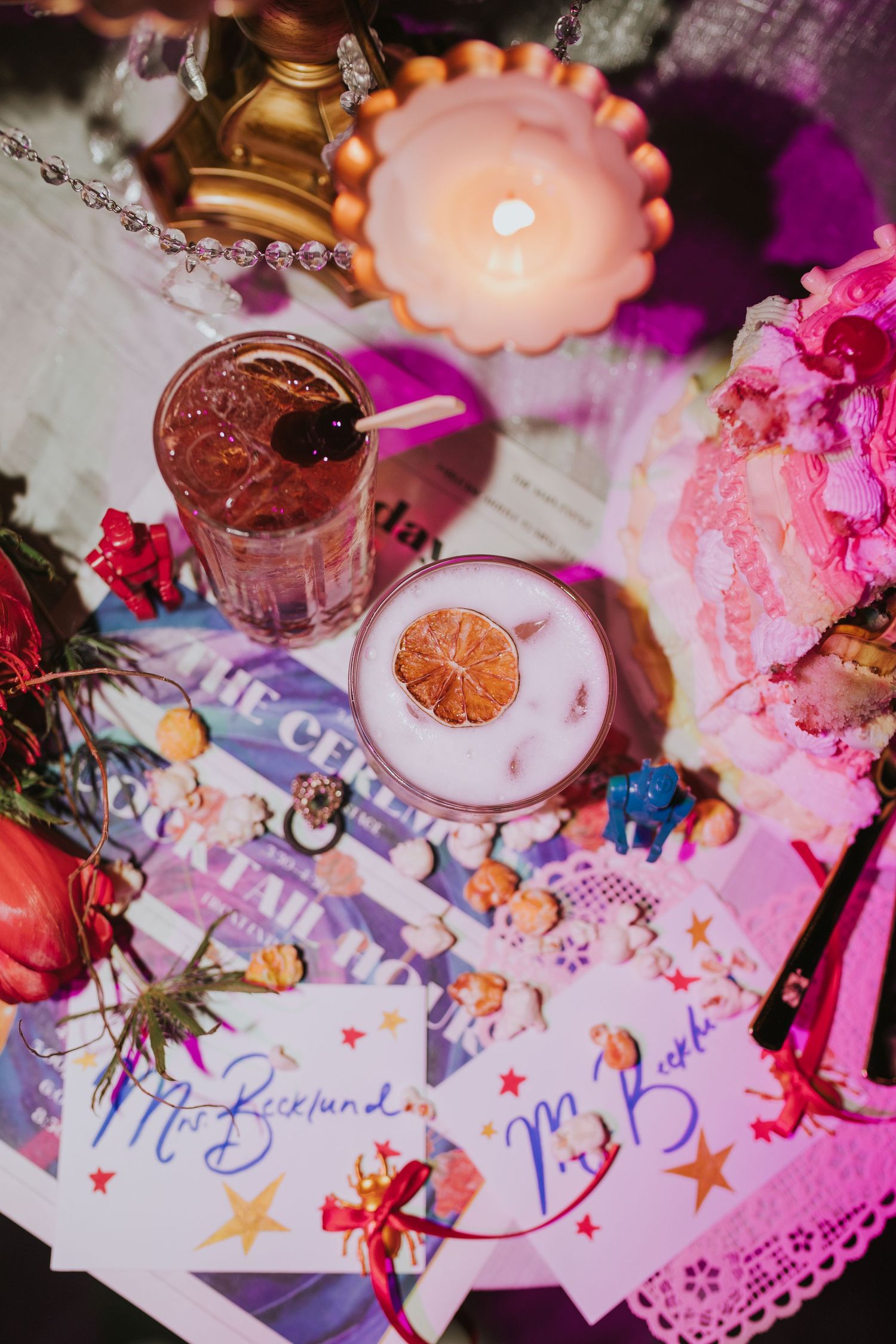 Overhead view of wedding cocktails and place cards with candles and colorful decorations at the Floridian Social St Petersburg.