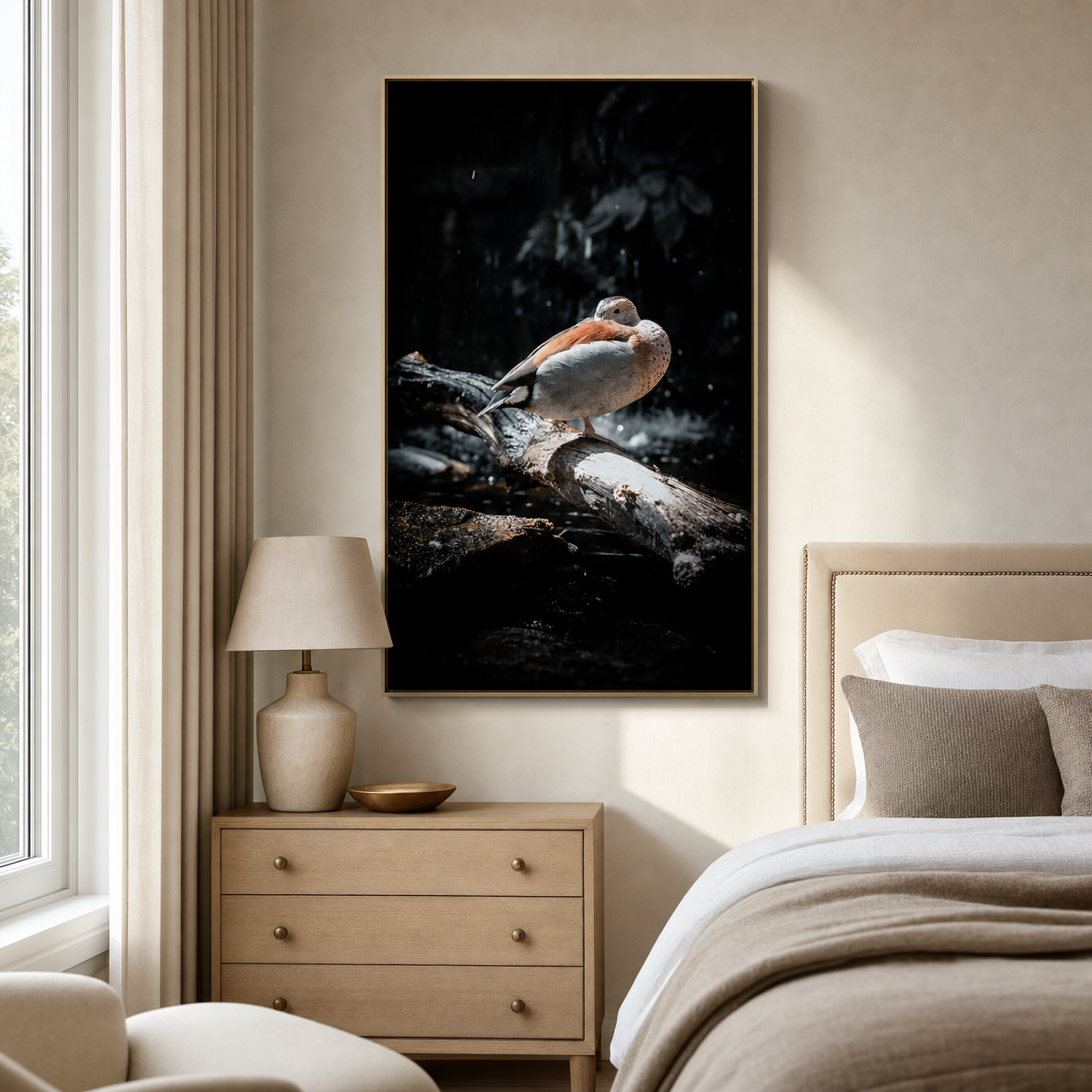 Framed canvas of a robin perched on a branch against dark background, hanging above a bedroom dresser.