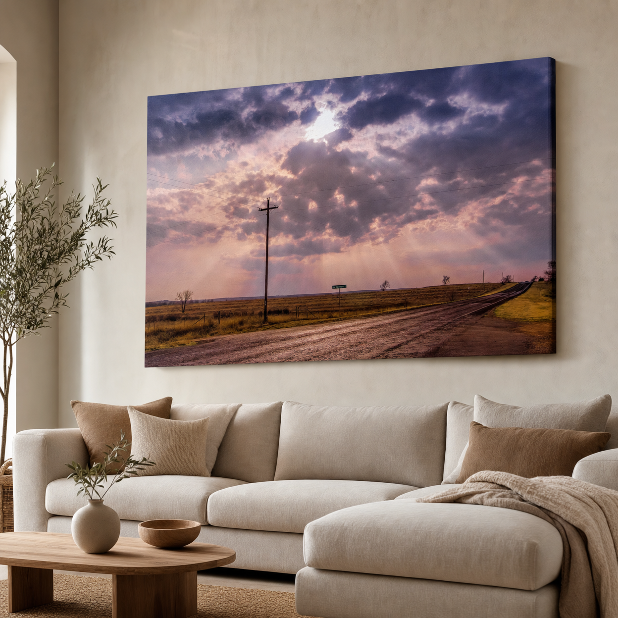 Canvas wall art of a dramatic stormy sky over a rural dirt road with a utility pole and golden light rays.