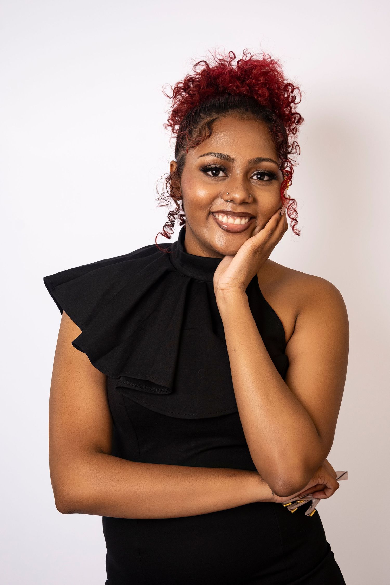 Smiling businesswoman posing in a black dress during a branding session by a Central Florida Photographer.