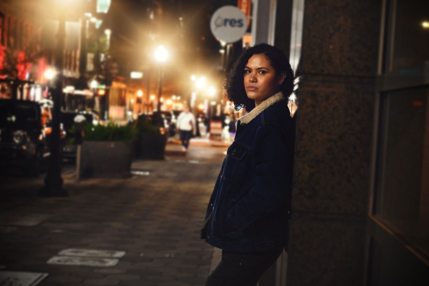High school senior posing in a city setting at night during a portrait session by a Central Florida Photographer.
