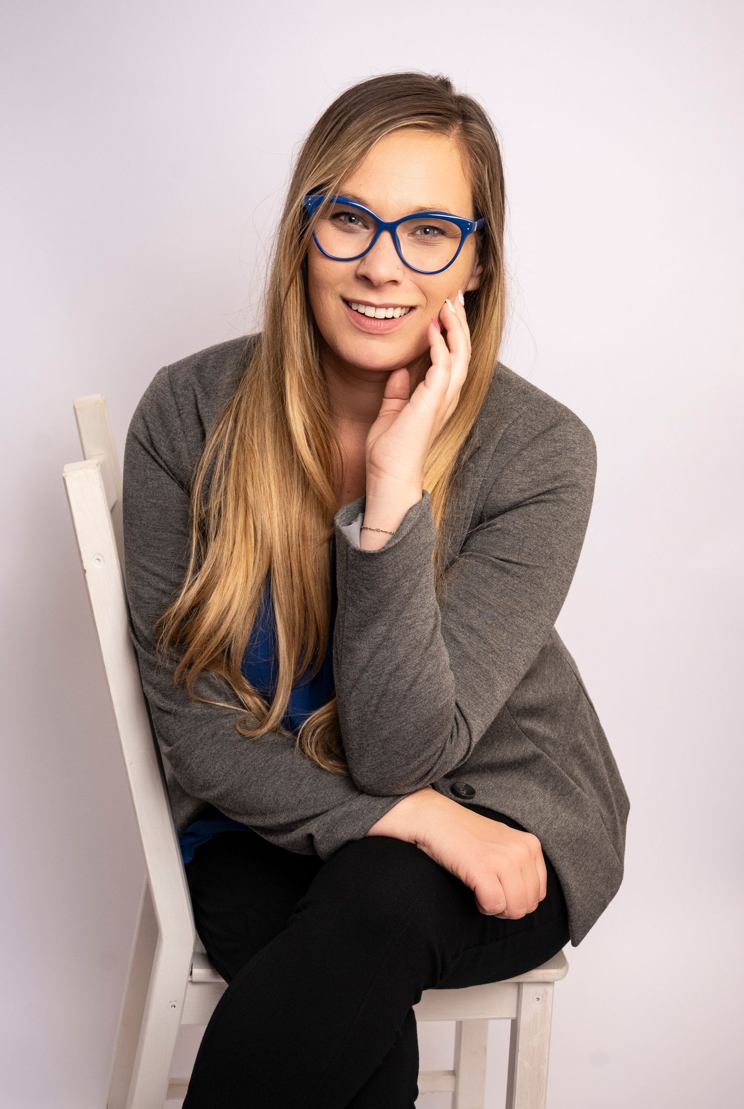 Professional woman seated on a chair during a personal branding session by a Central Florida Photographer.