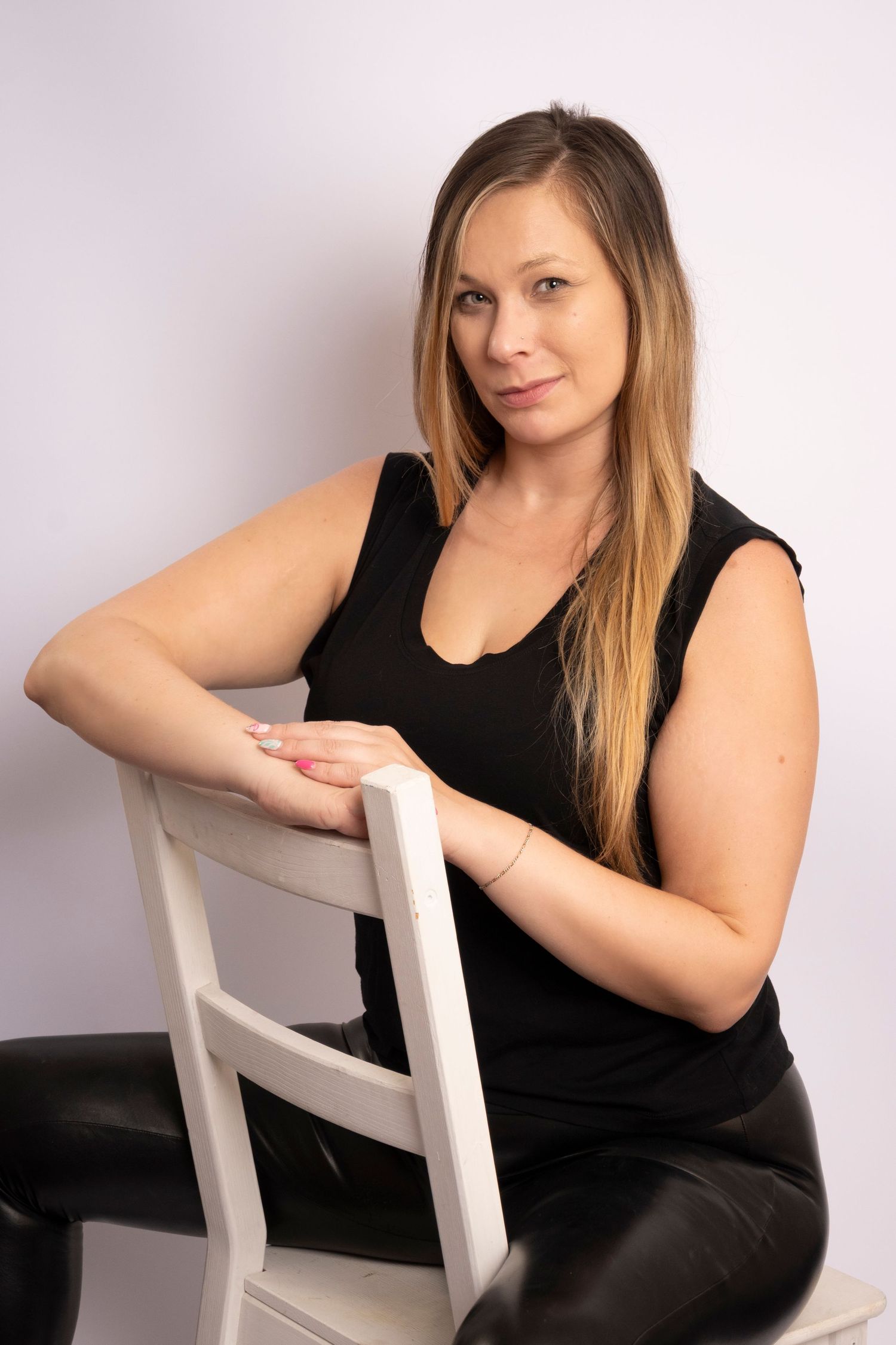 Businesswoman seated on a chair during a professional branding session by a Central Florida Photographer.