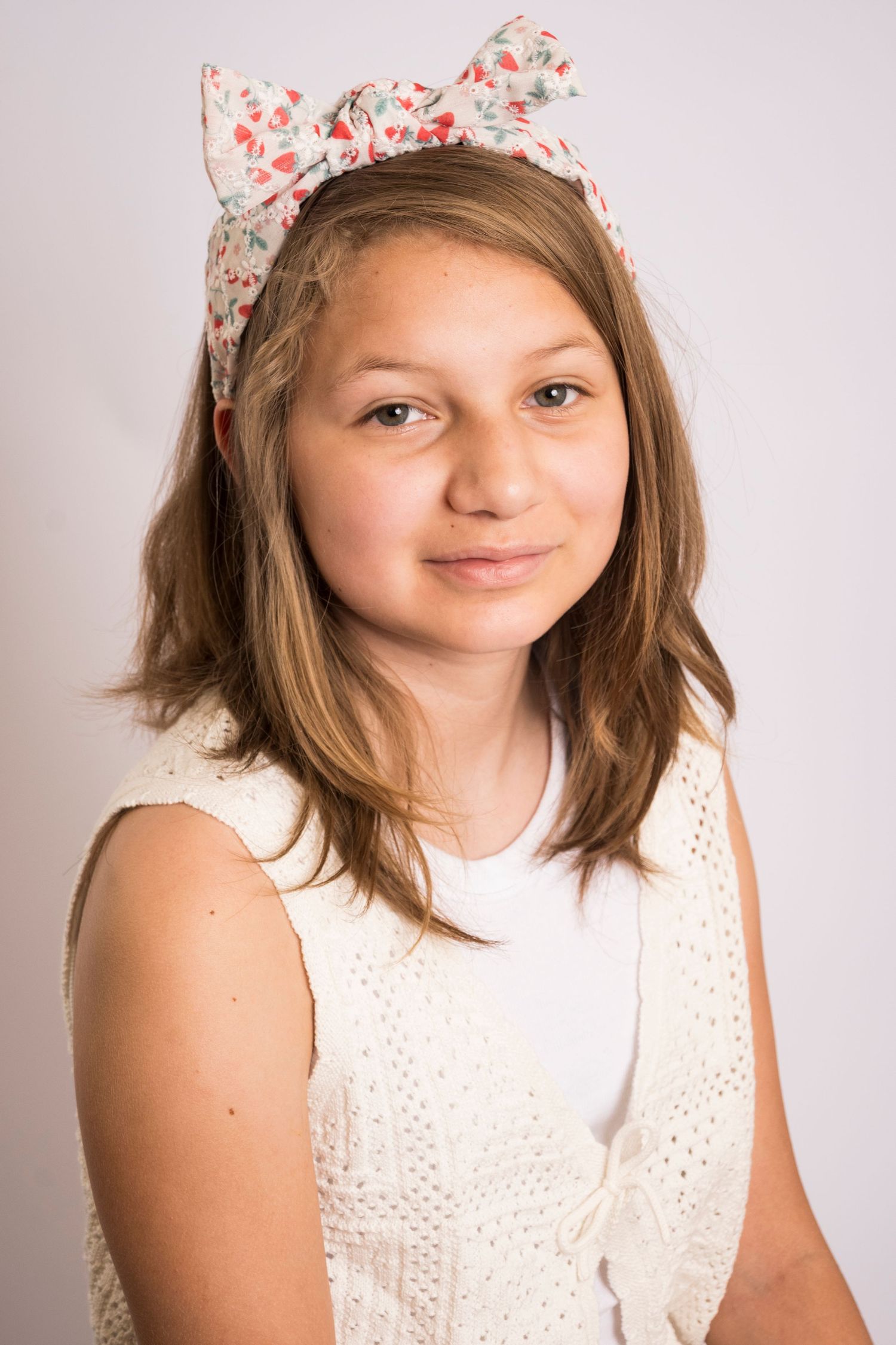 Young girl smiling during a studio portrait session by an orladno Florida Photographer.