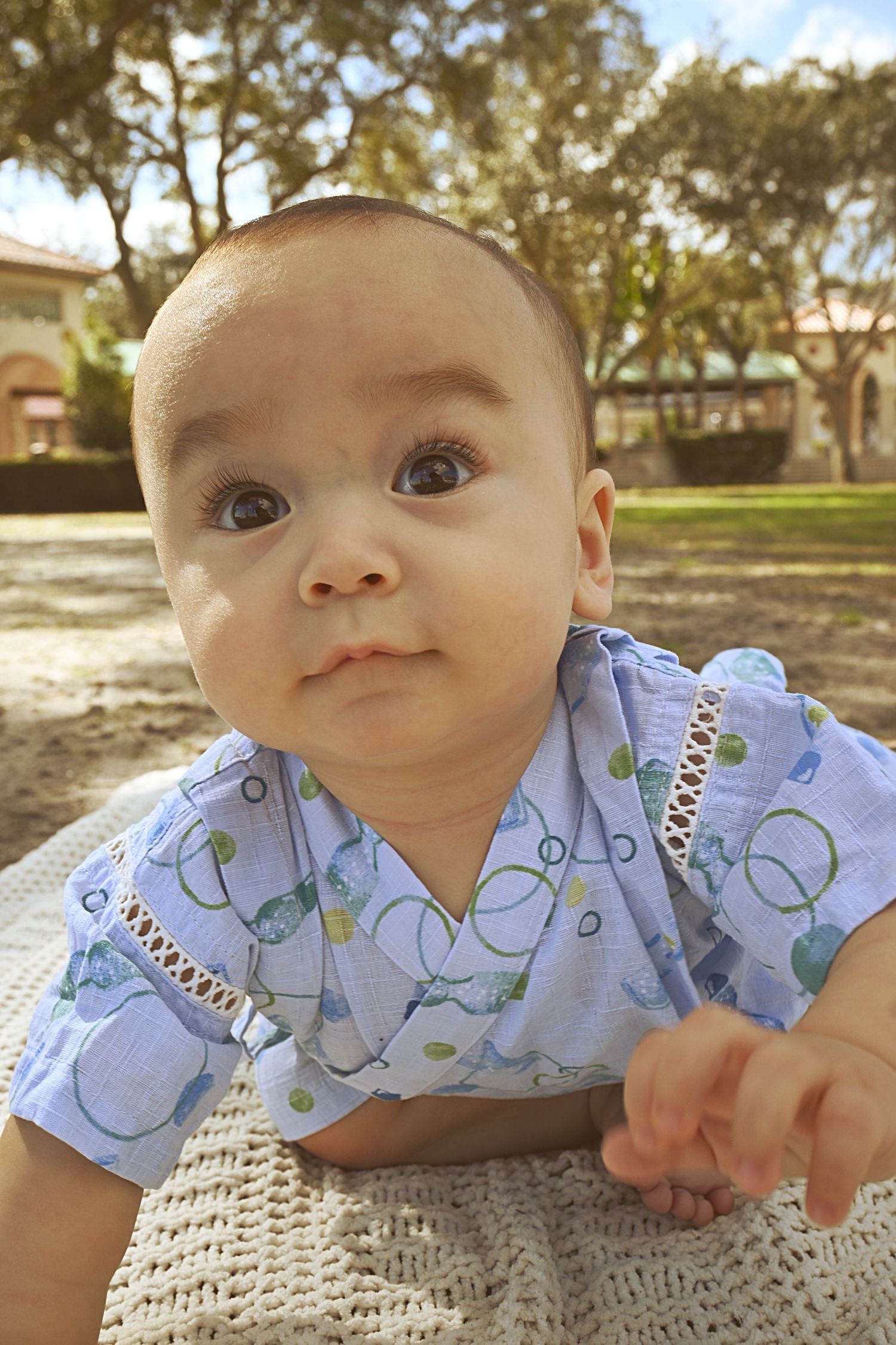 Baby exploring outdoors during a natural light milestone portrait by a Central Florida Photographer.