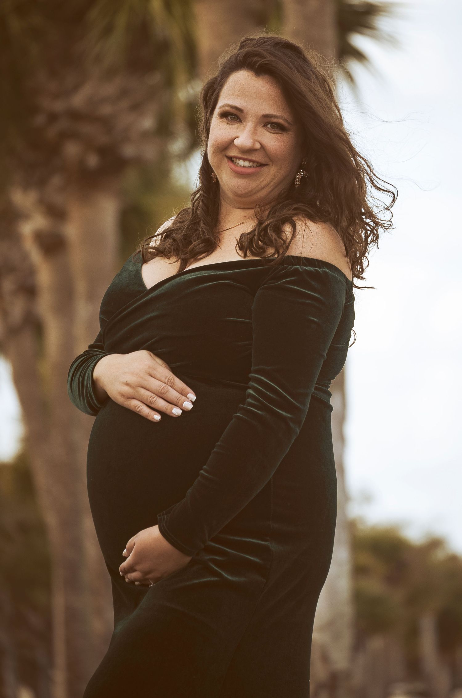Expectant mother posing outdoors during a maternity portrait by a Central Florida Photographer.