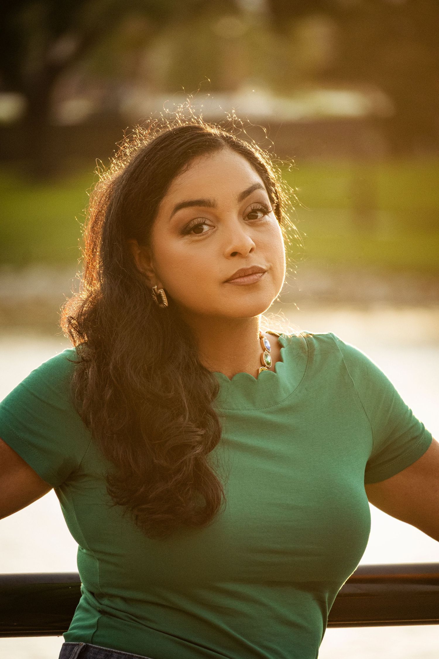 Senior girl smiling in soft evening light during an outdoor portrait session by a Central Florida Photographer.