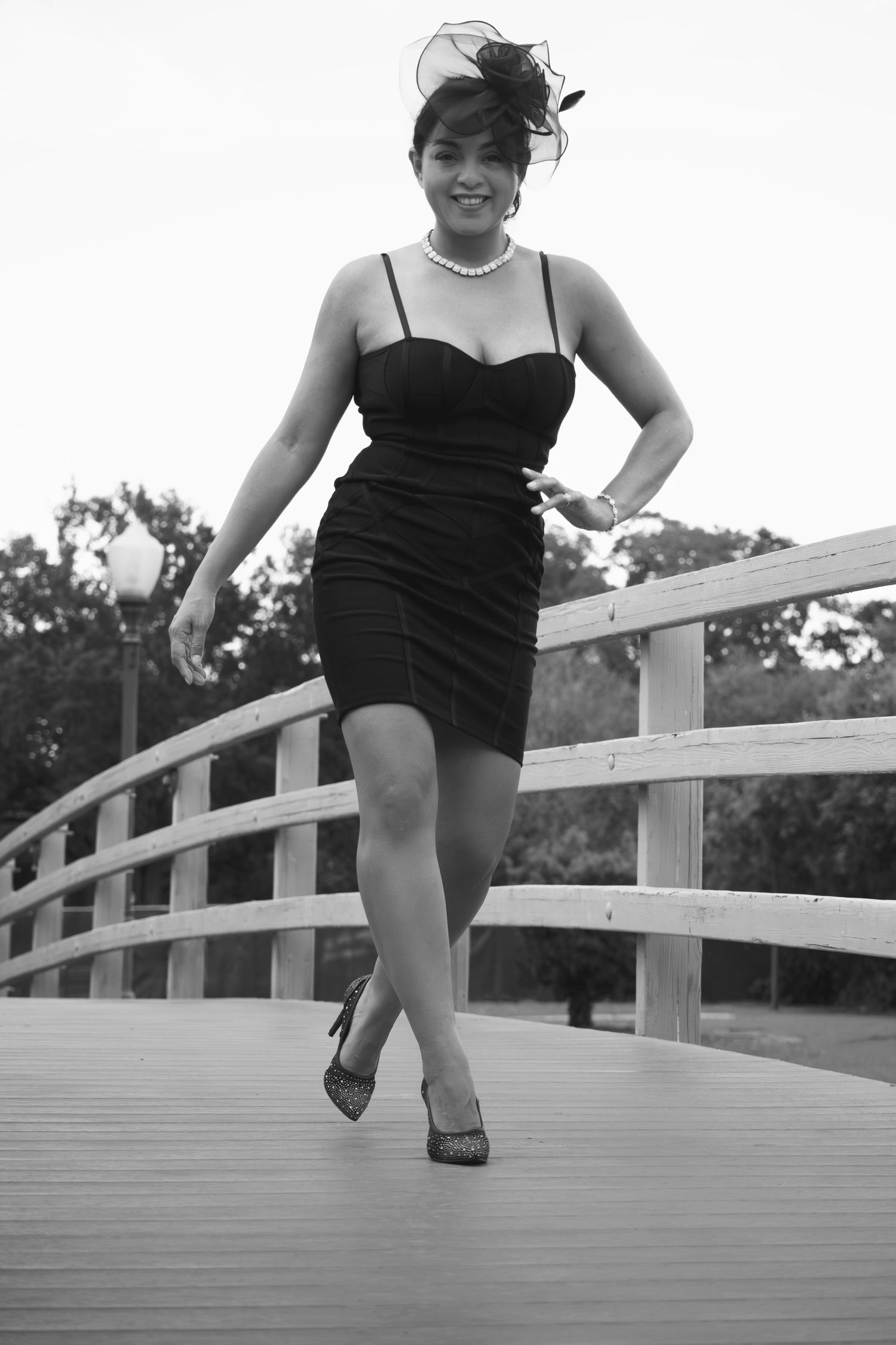 Black and white portrait of a woman walking across a bridge during a lifestyle session by a Central Florida Photographer.