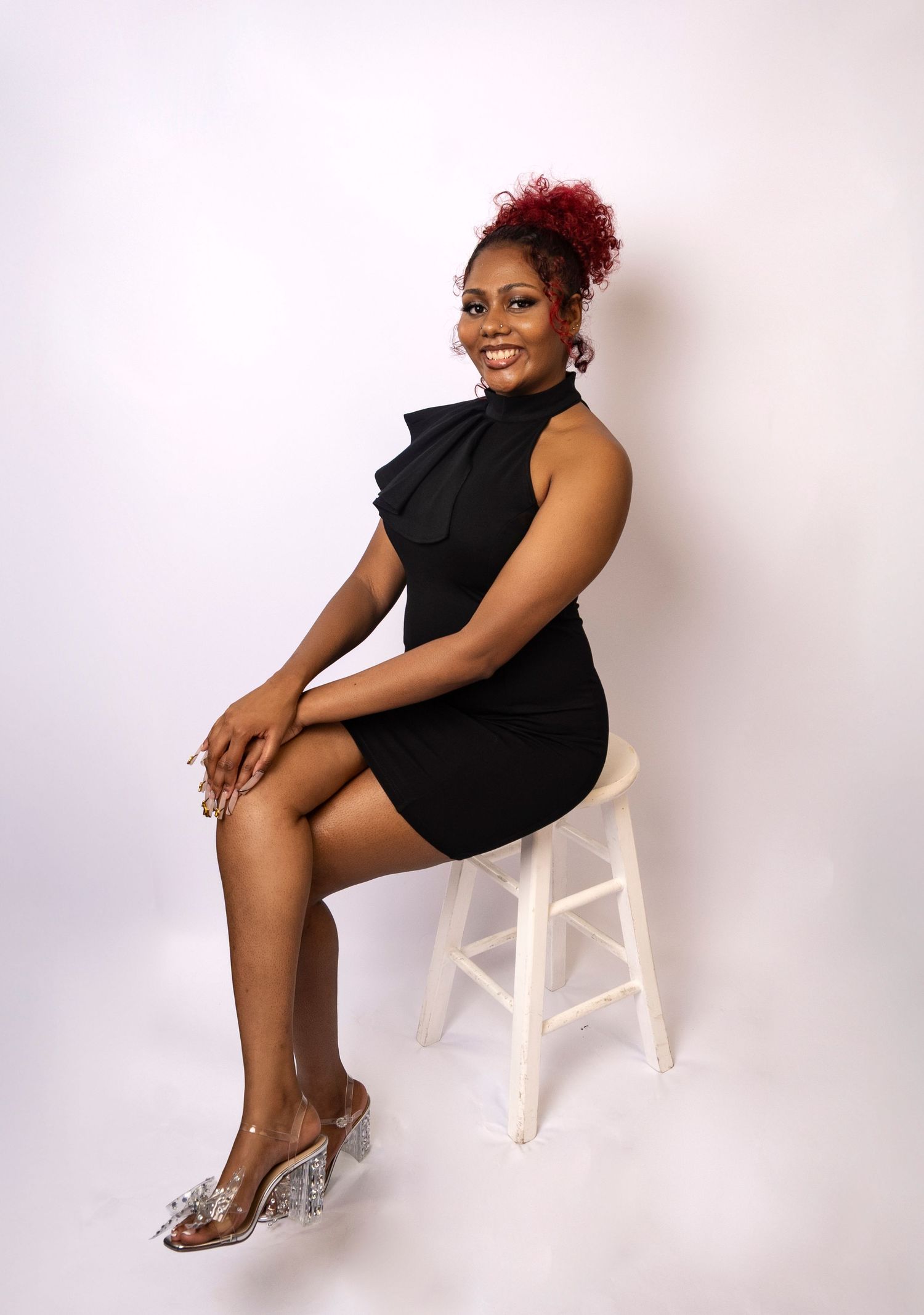Businesswoman seated on a stool during a professional studio branding session by a Central Florida Photographer.