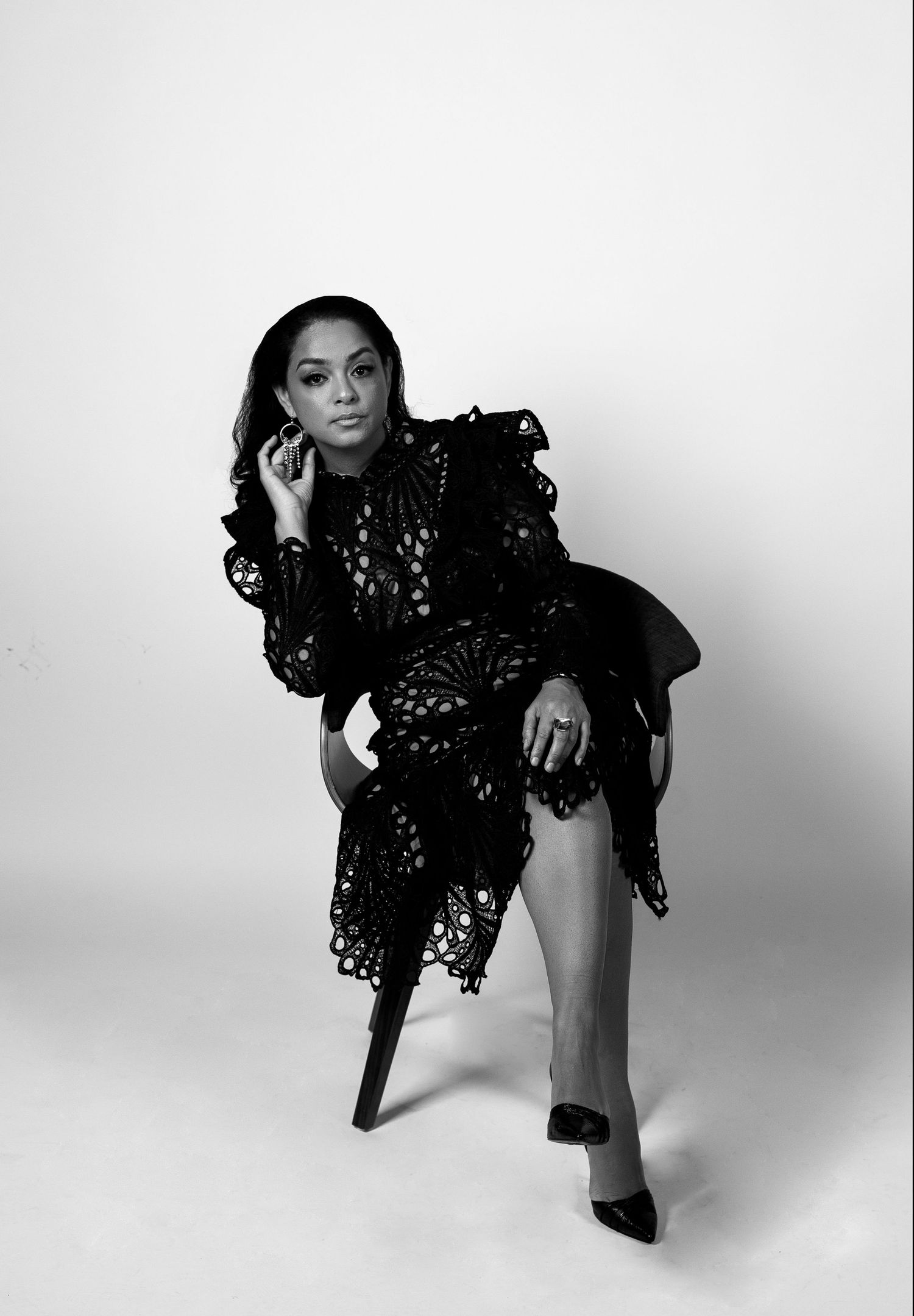 Black and white fashion portrait of a woman posing in a studio session by a Central Florida Photographer.